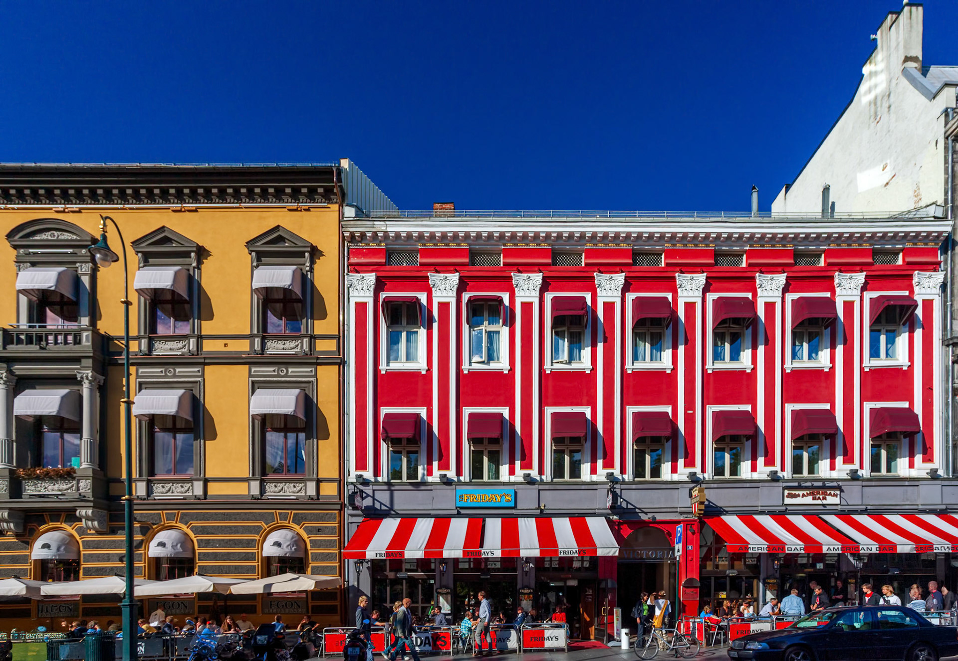 Oslo, Norway, Aug 10 2017, Vibrant facades line Karl Johans street in Oslo, filled with outdoor cafes and bustling pedestrians enjoying the sunny weather.