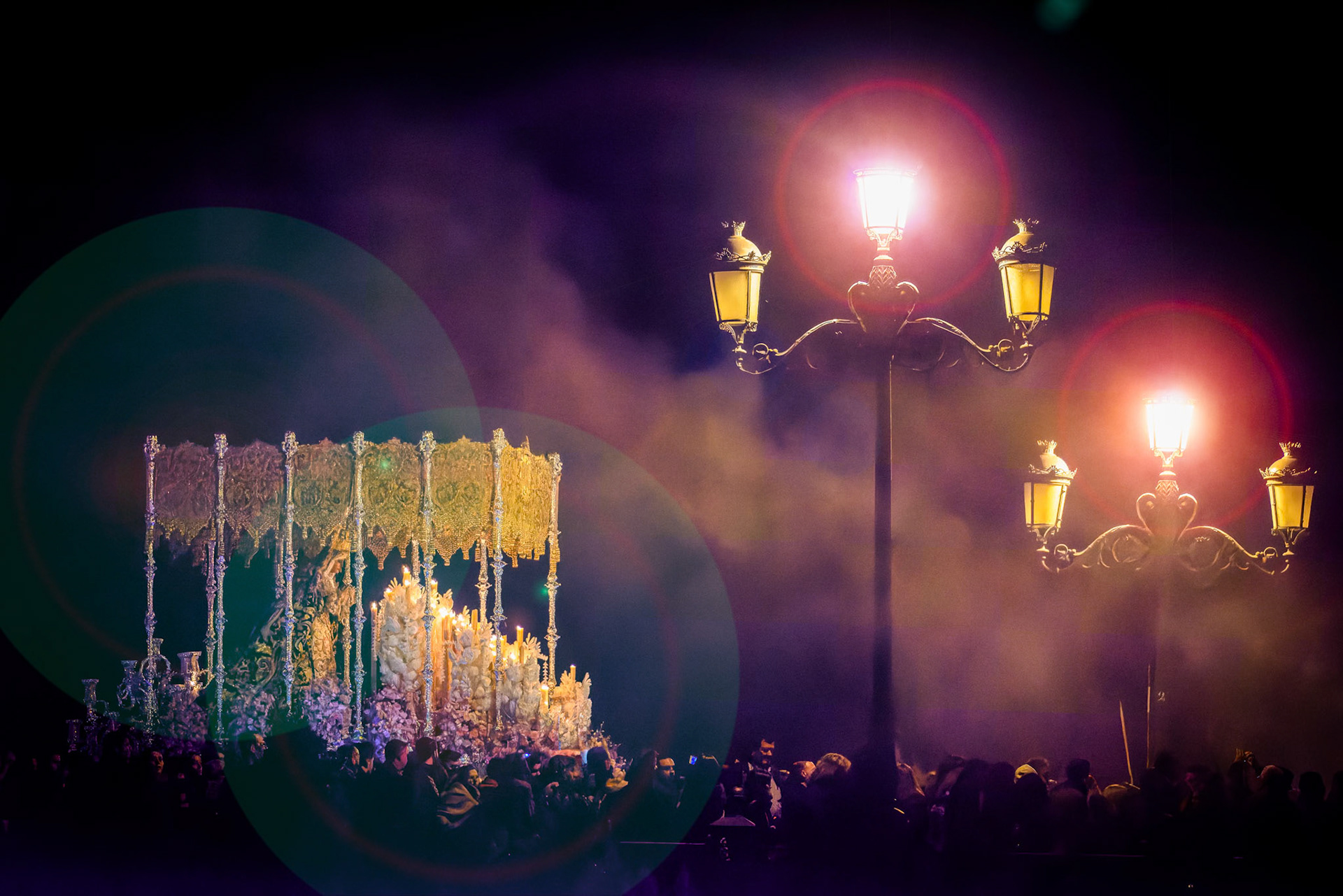 Seville, Spain, March 25 2016, Palio of Esperanza de Triana crosses the bridge on Good Friday night in Seville, Spain, seen with street lamps and crowd.