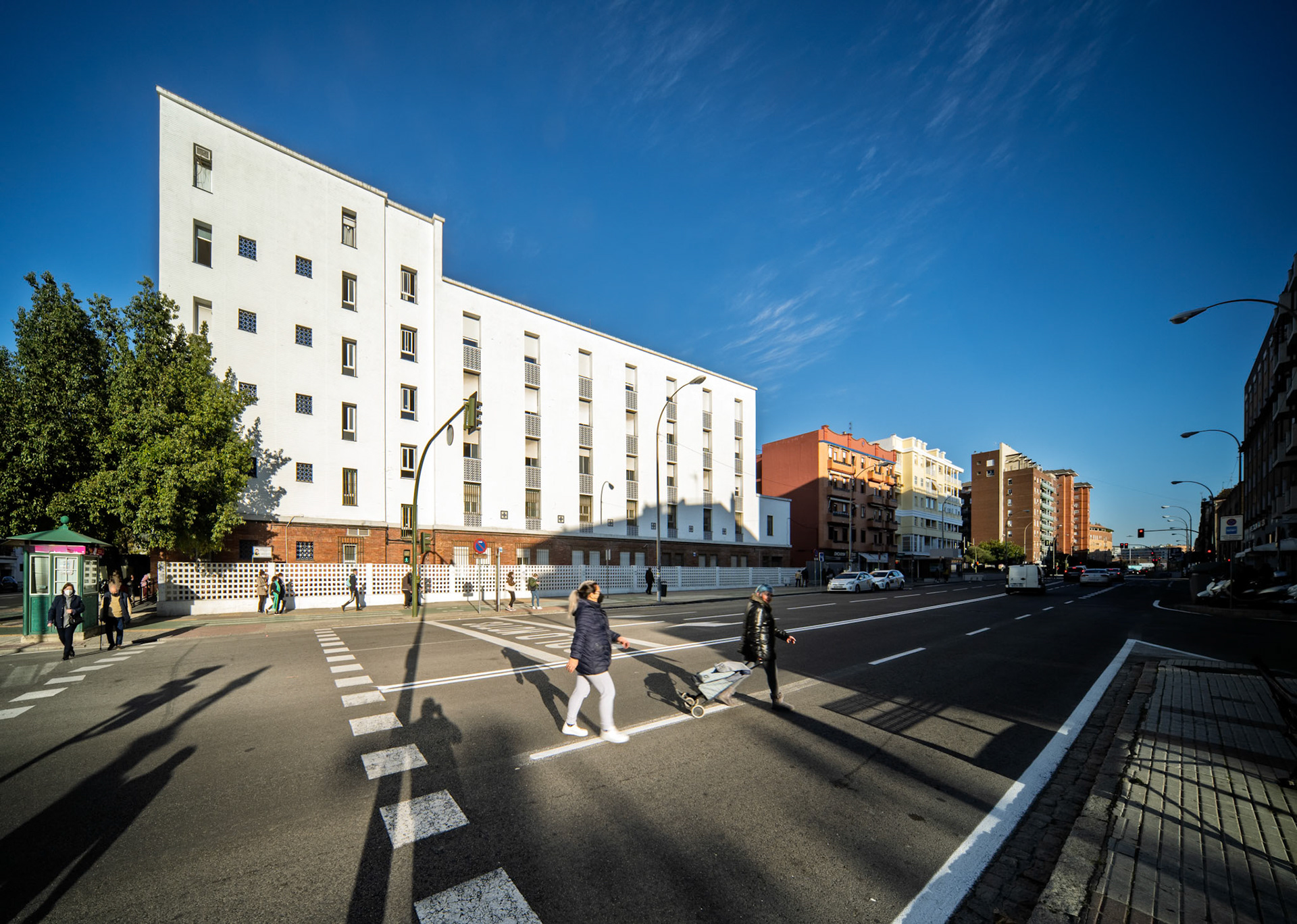 People cross the street at Calle Jose Laguillo in Seville, near the Esperanza Macarena health center designed by Garcia Mercadal in 1964.