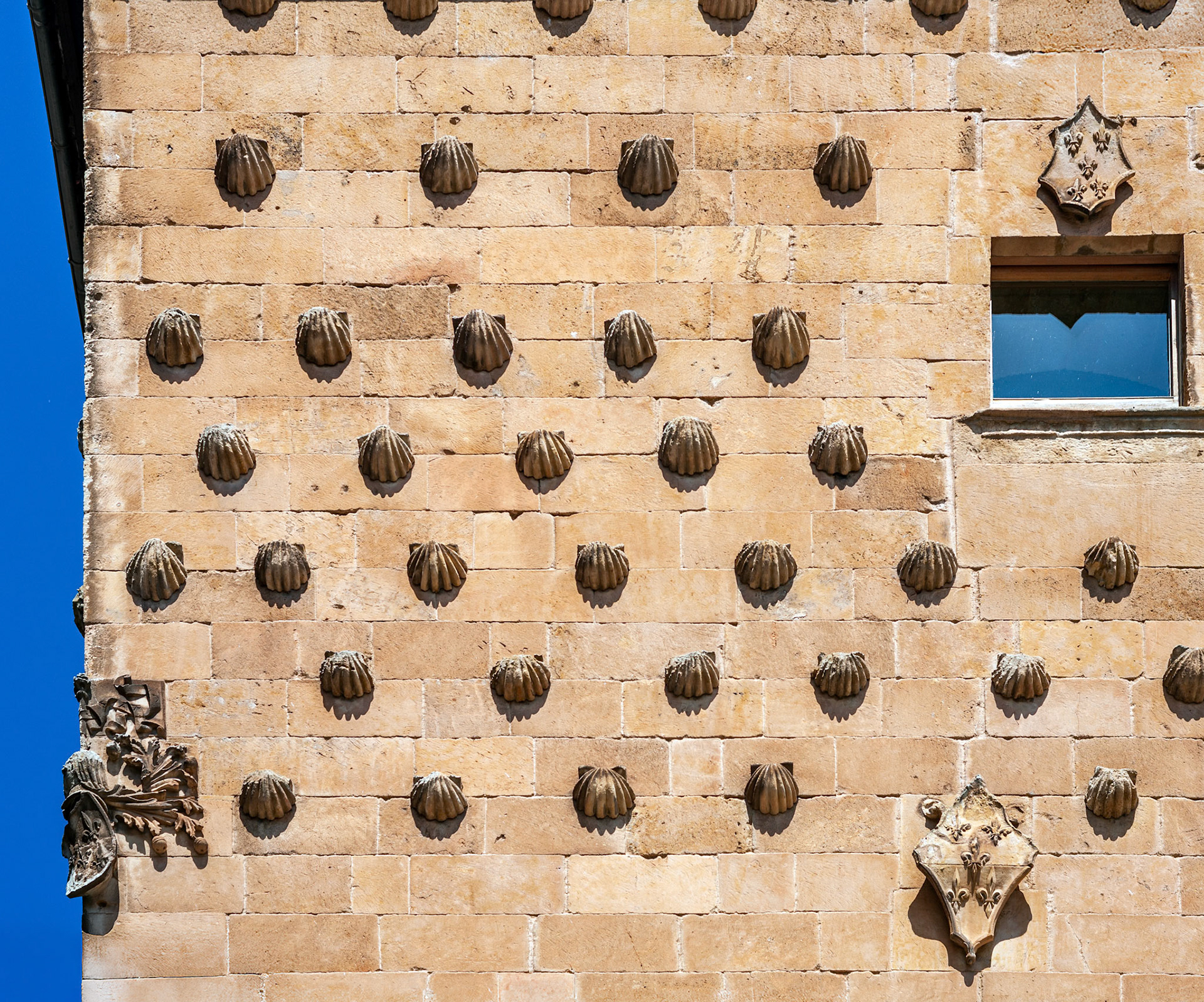 Architectural detail of Casa de las Conchas facade adorned with shell motifs