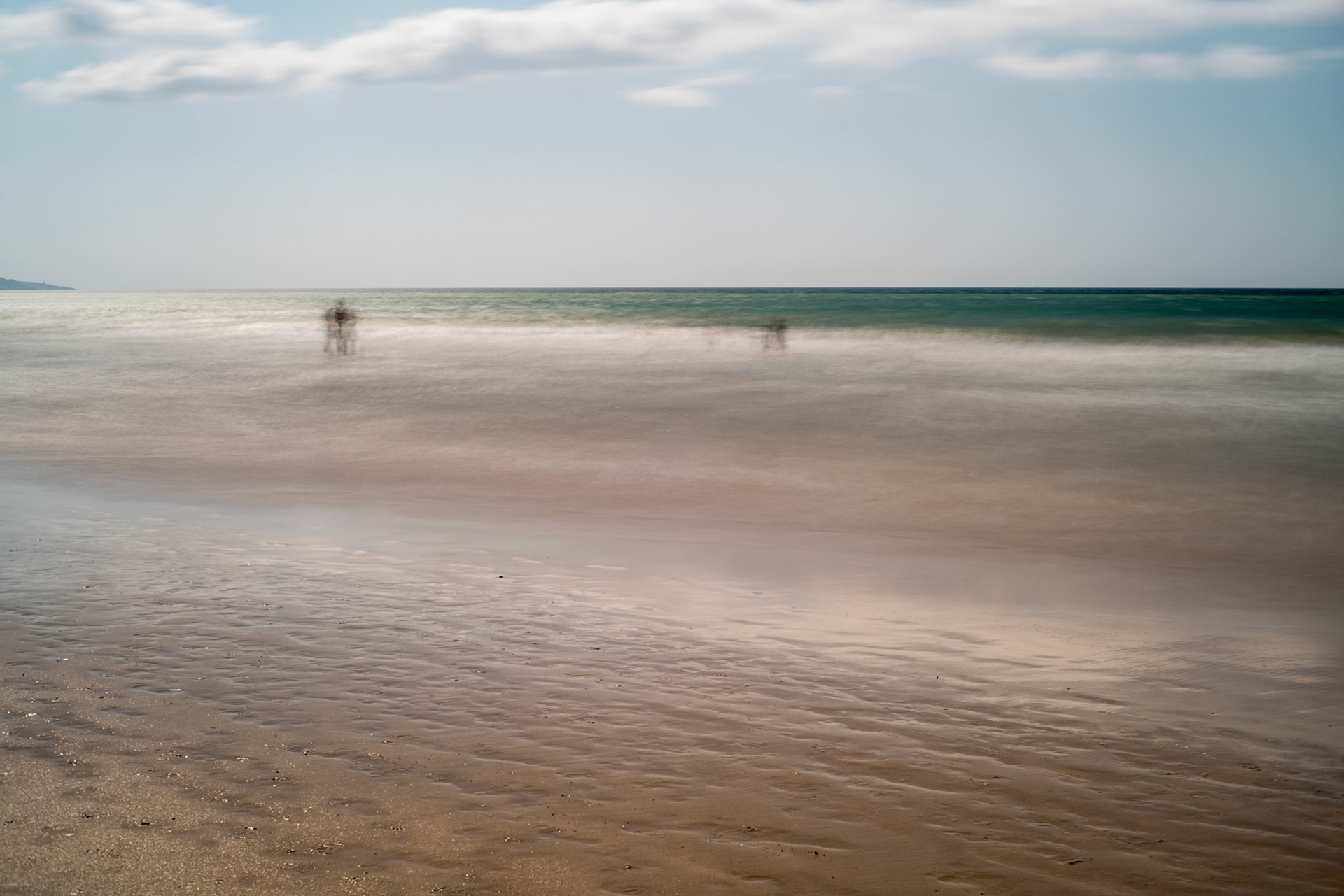 Ghostly people on a beach, long exposure shot, Playa del Carmen, Barbate, Andalusia, Spain.