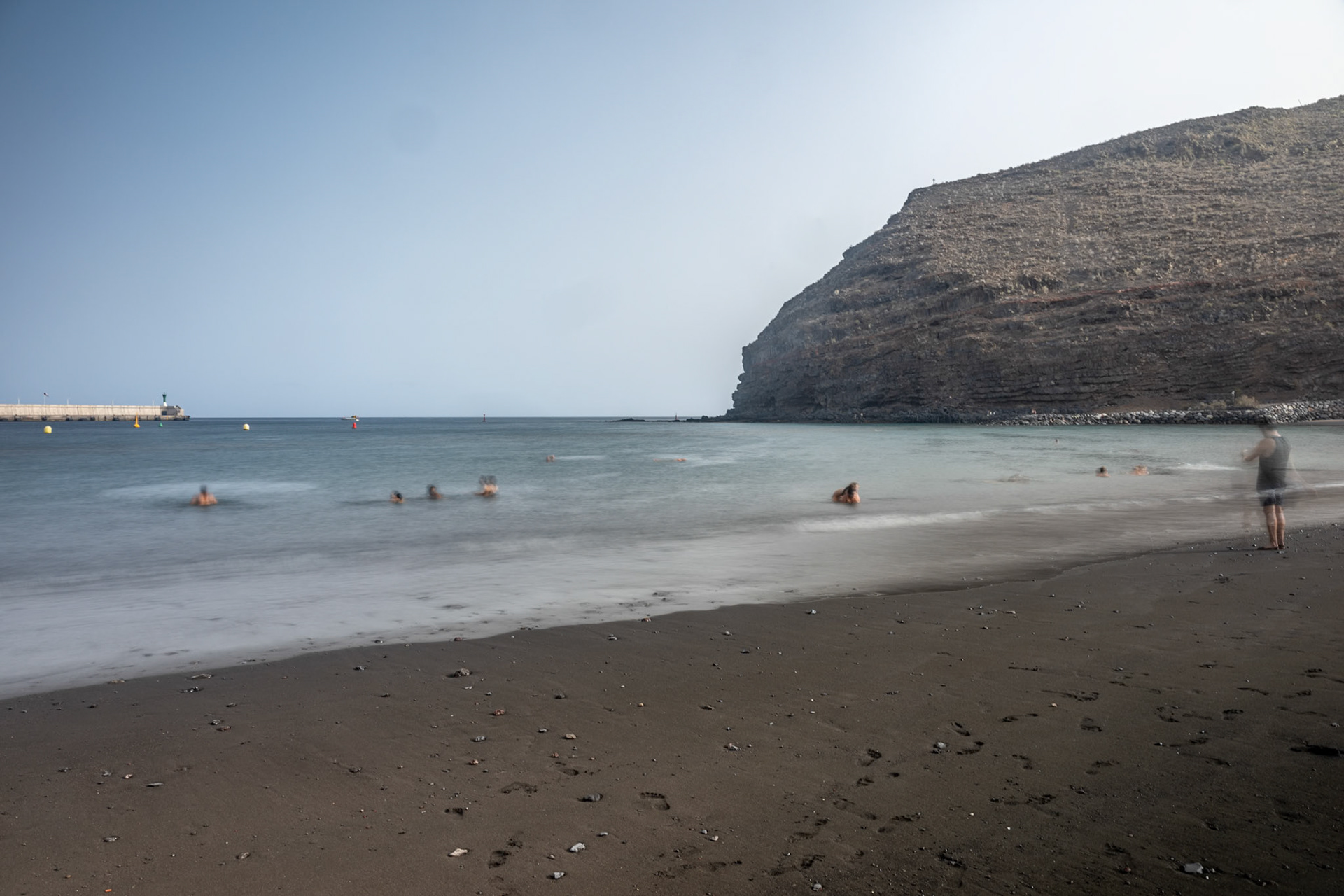 Long exposure of San Sebastian de la Gomera beach in the Canary Islands, featuring a calm beach and gentle waves.