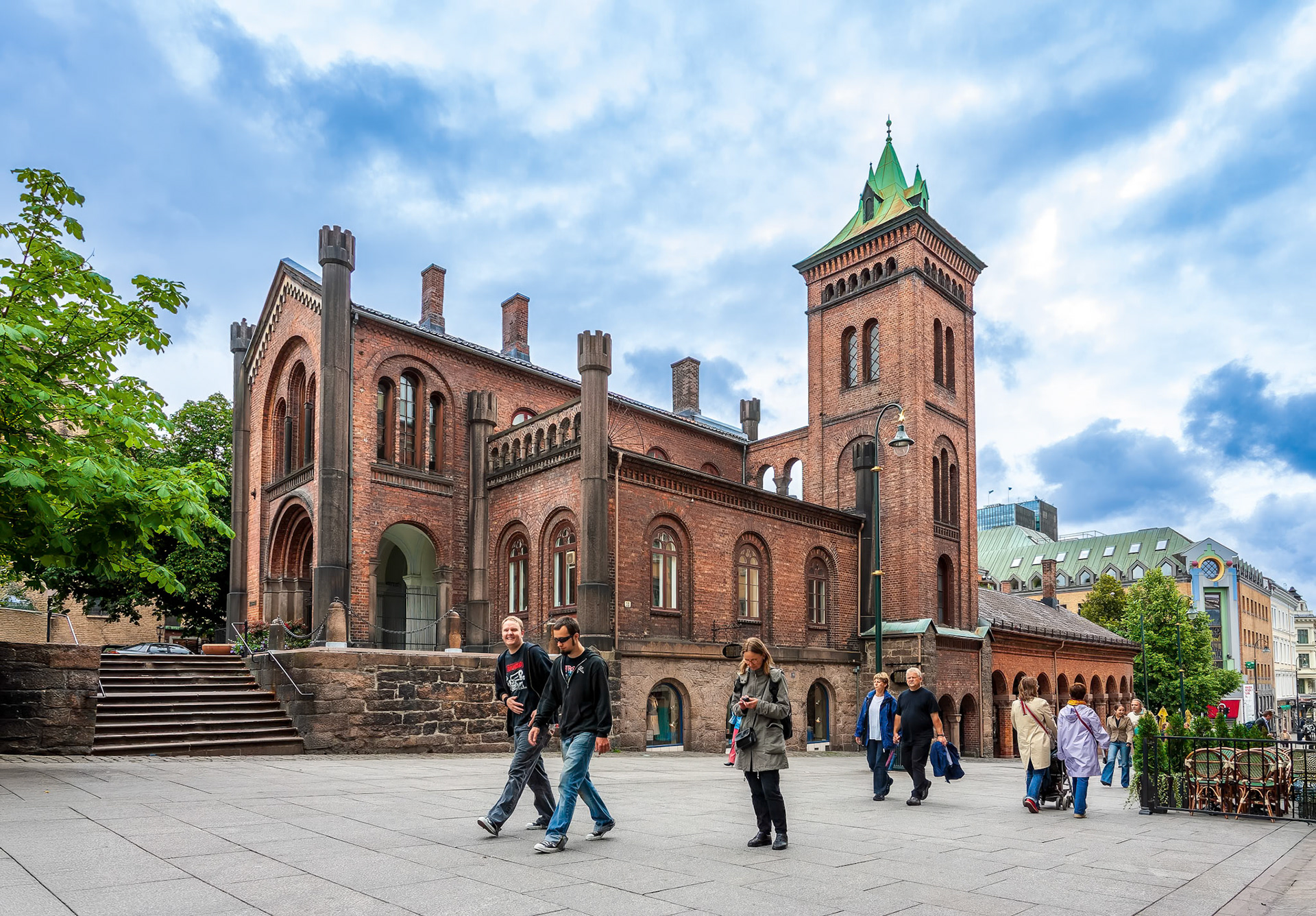 Oslo, Norway, Aug 10 2017, Visitors stroll past Brannvakten, a historic fire station in Oslo, showcasing impressive architecture on a cloudy day.