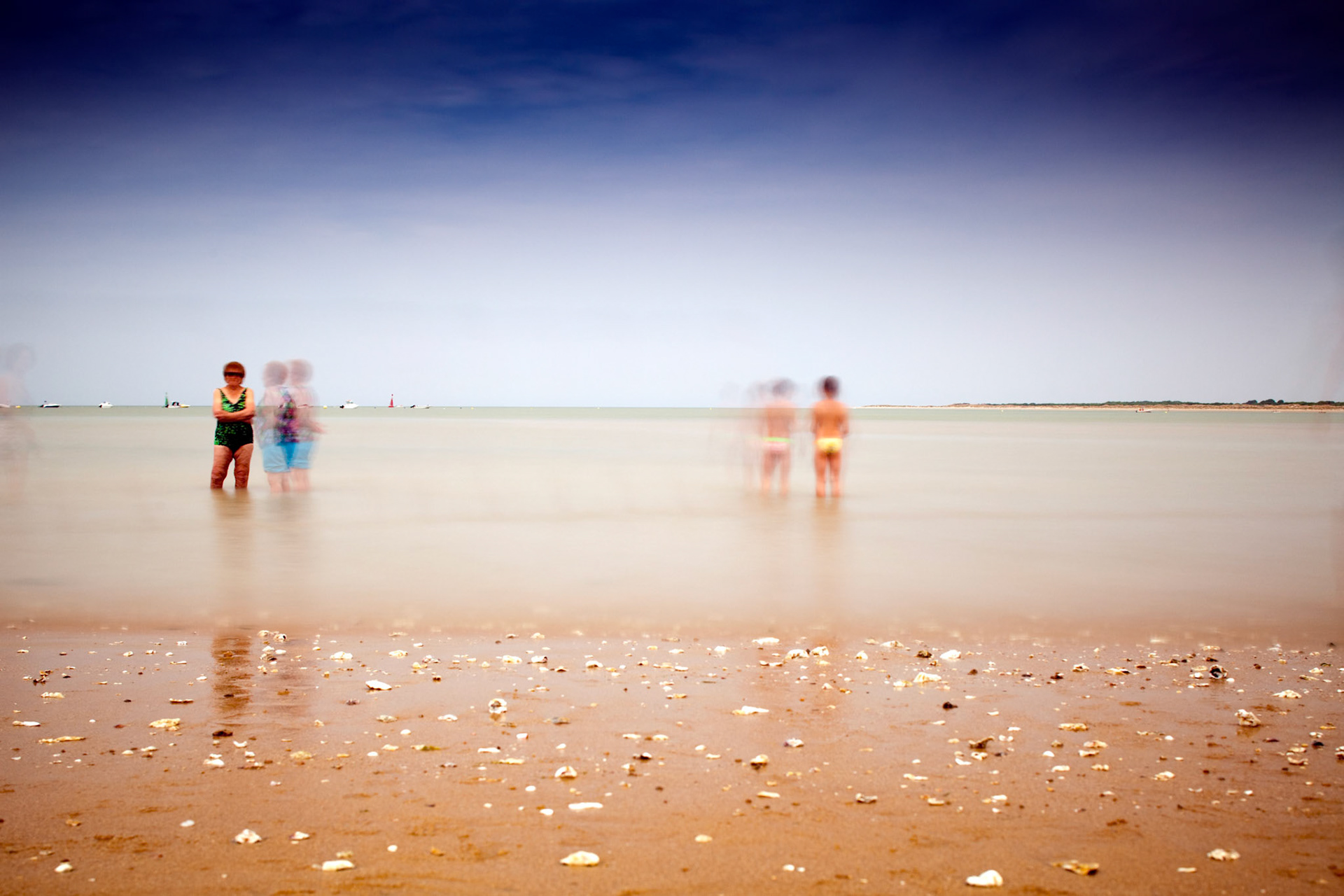 People on the beach, Sanlucar de Barrameda, Spain. Daylight long exposure shot by the use of neutral density filters.