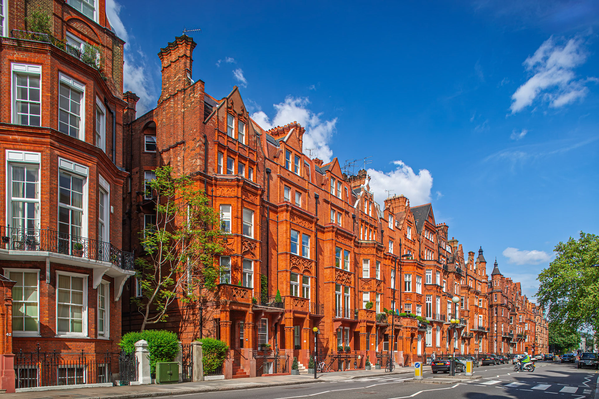 Victorian buildings made of red brick line the street on Pont Street in Kensington.