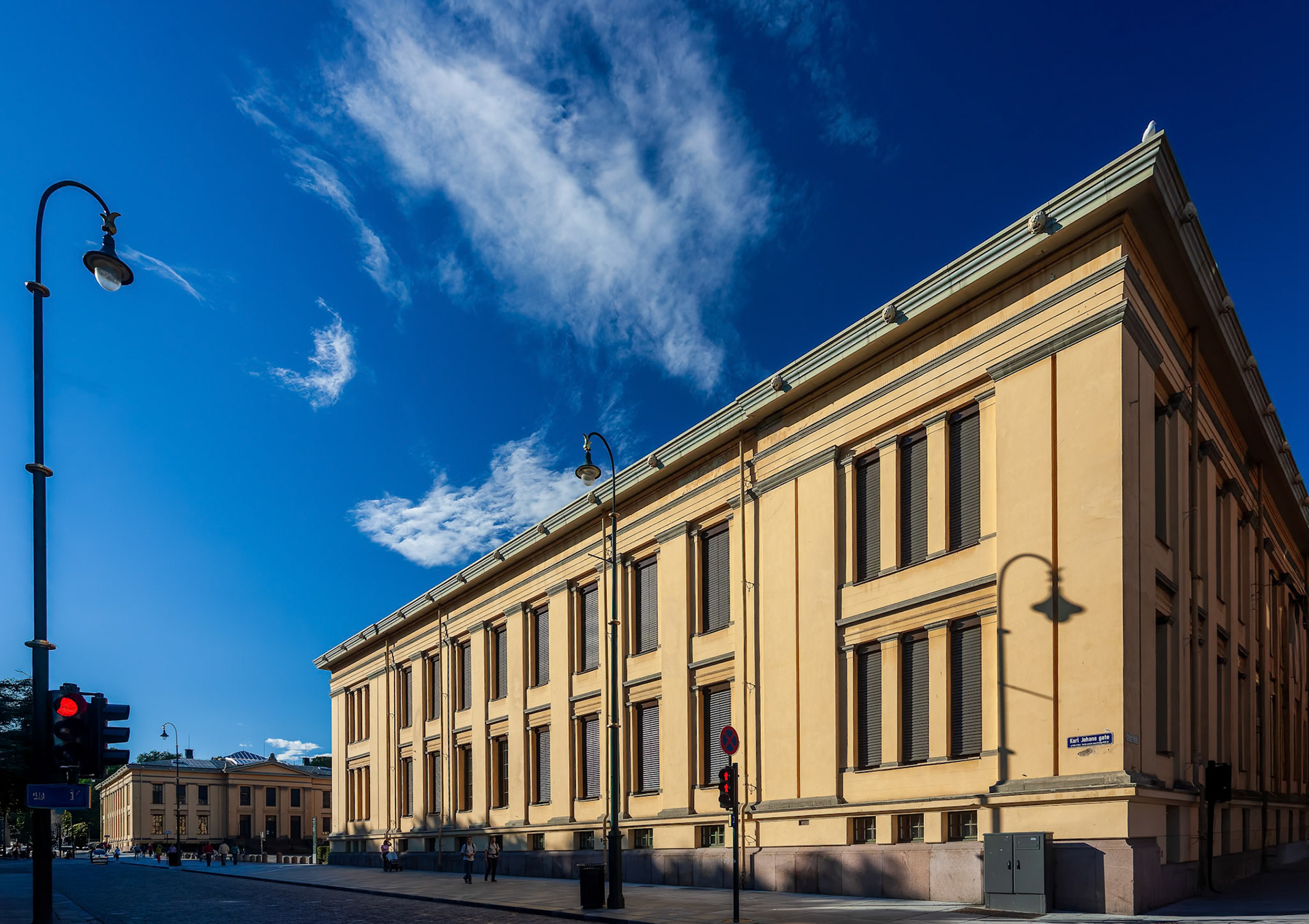 The University of Oslo building features unique architecture set against a clear blue sky, reflecting Oslo's vibrant vibe.
