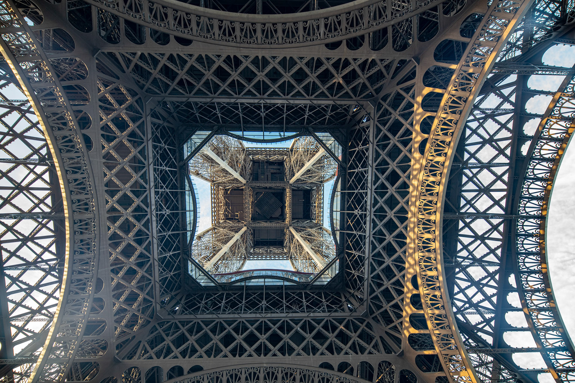 The Eiffel Tower stands tall against the blue sky in Paris.