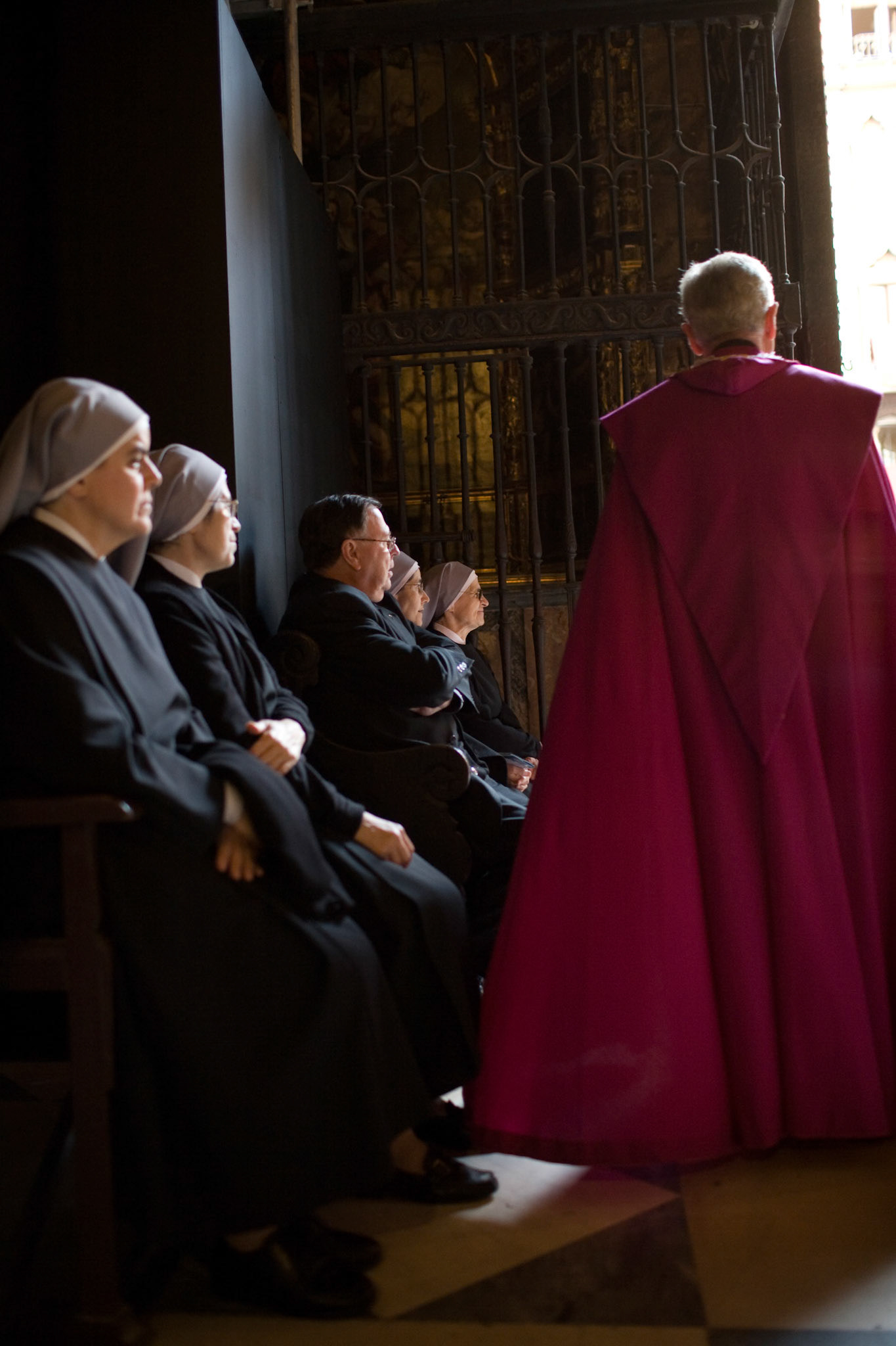 Clergy people inside Seville's cathedral, Spain