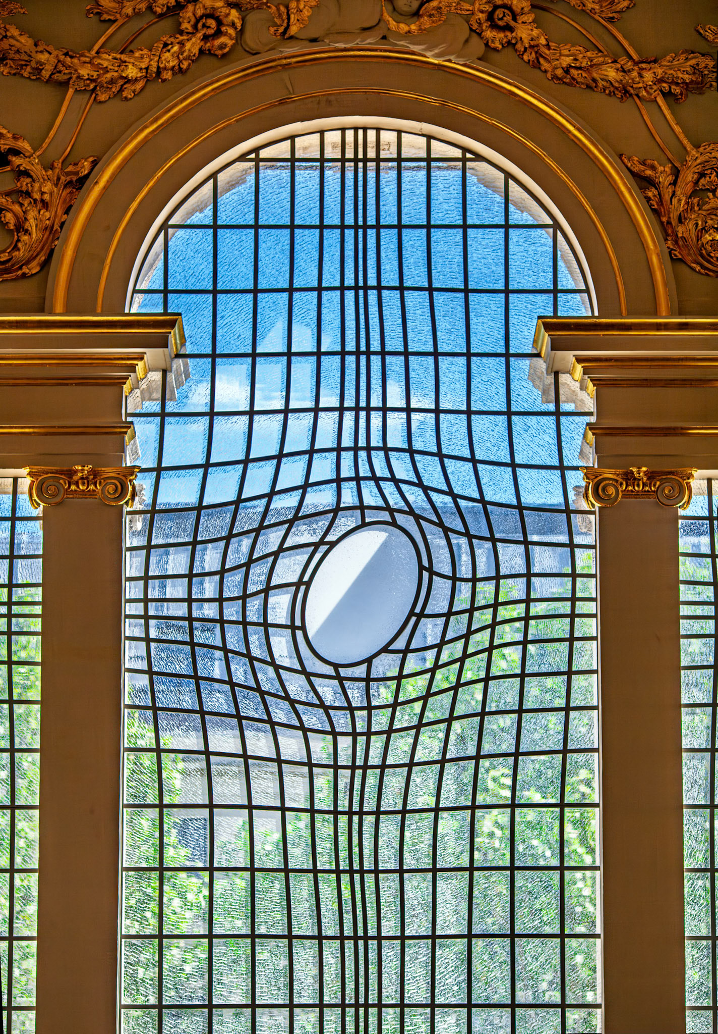 The New East Window at St Martin's in the Fields features a glass cross design. It represents modern art in a historic church in London.