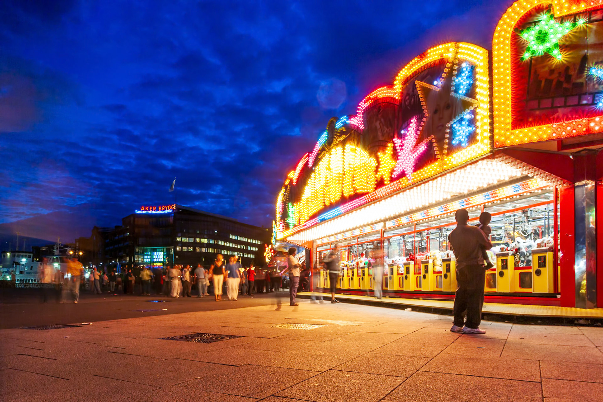 Oslo, Norway, Aug 10 2017, The fun fair at Aker Brygge in Oslo glows brightly during the evening, drawing crowds with its colorful lights and attractions.