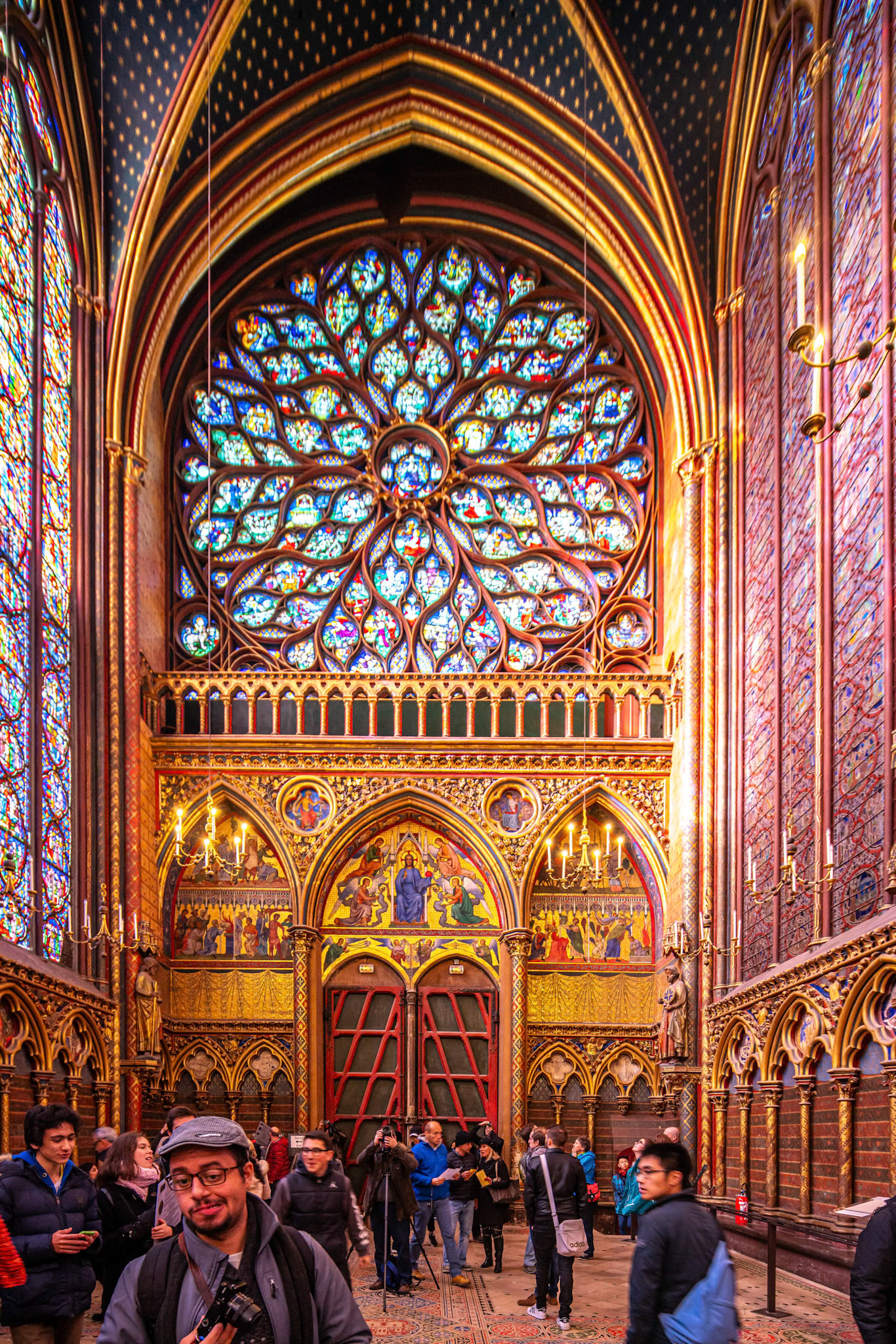 Tourists admire the stunning stained glass windows at the Sainte Chapelle.