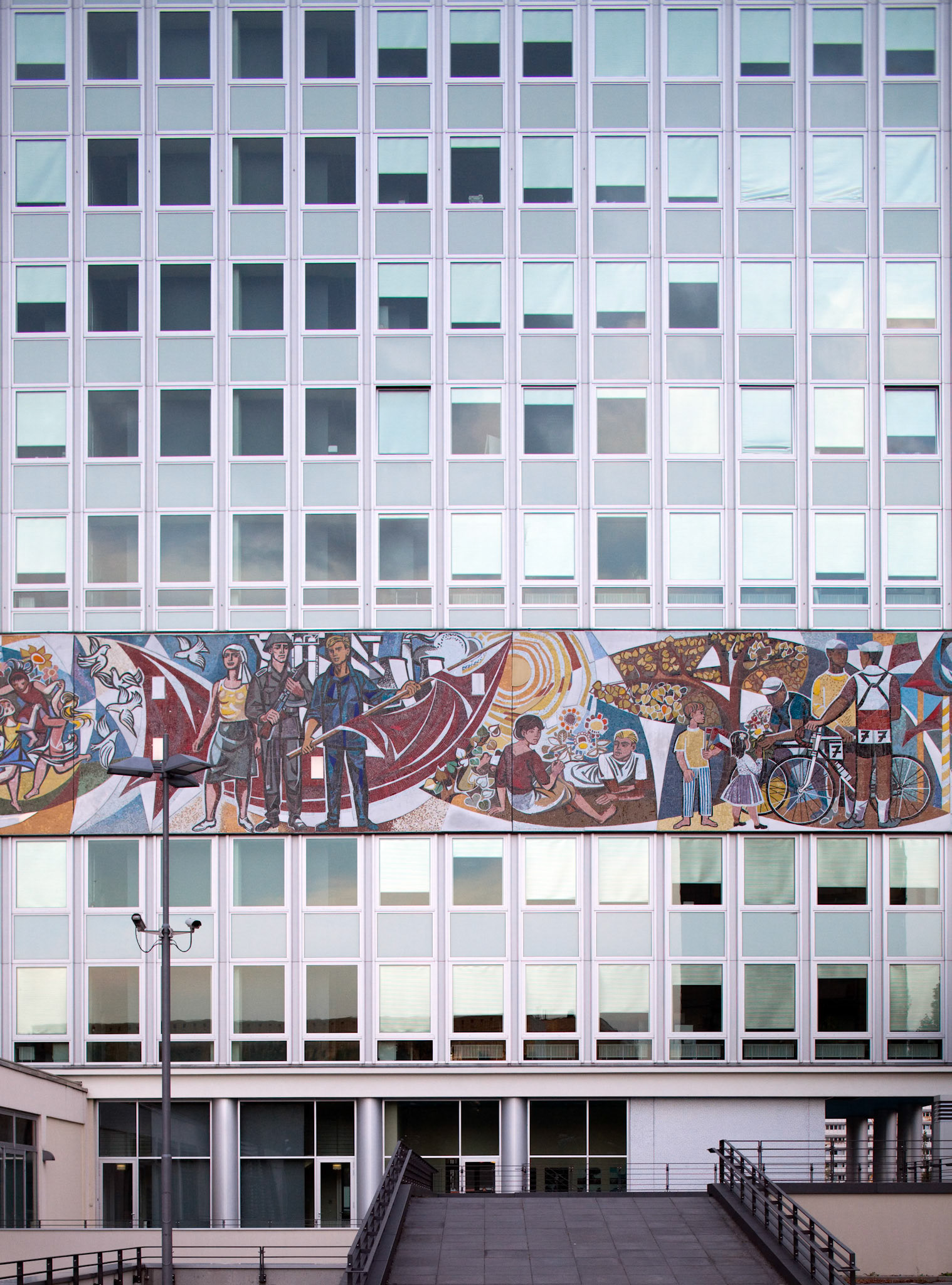 The Haus des Lehrers features a vibrant Socialist mural by Walter Womacka, showcasing history and culture in Berlin\'s Alexanderplatz.