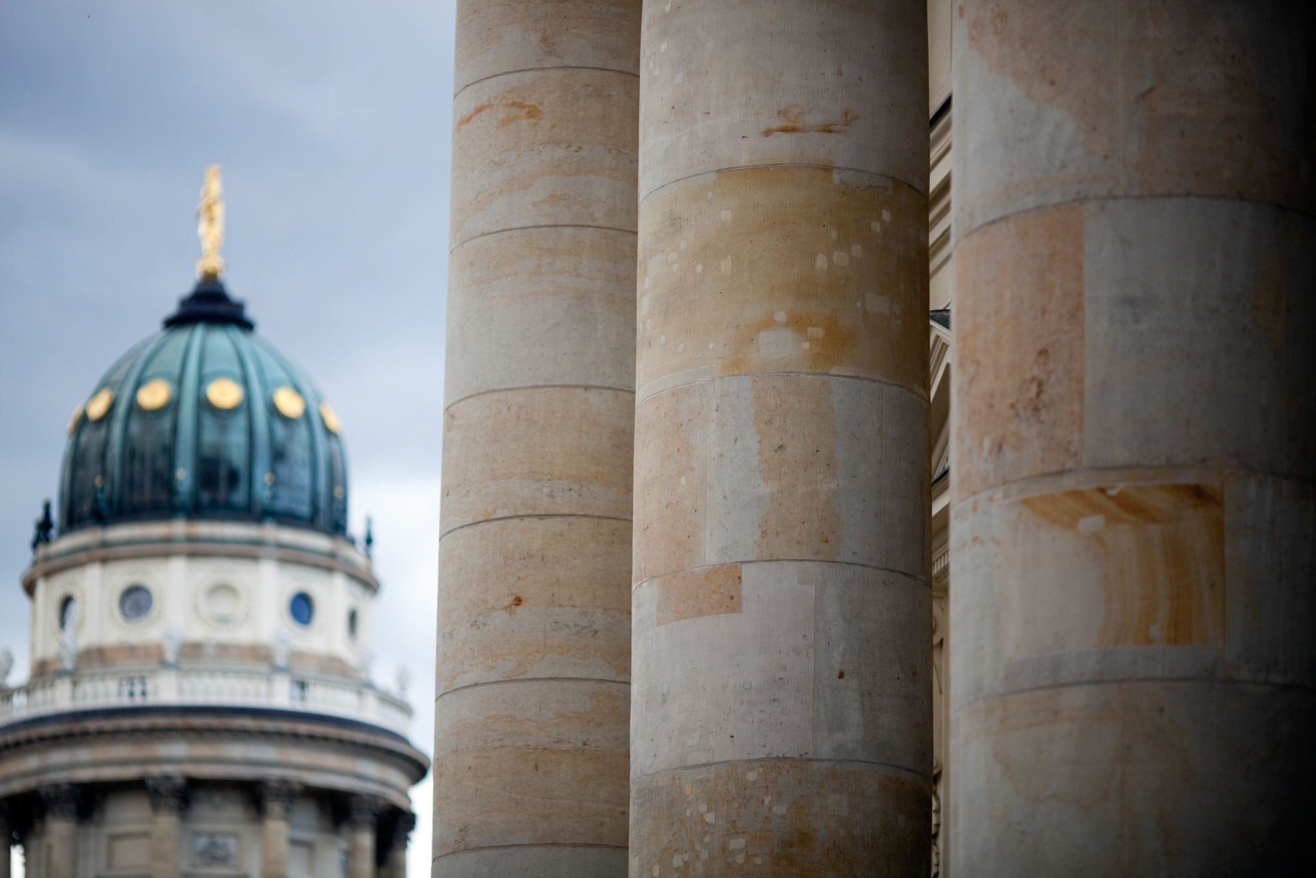 The Konzerthaus columns tower with the German Cathedral dome majestically in the backdrop at Gendarmenmarkt.