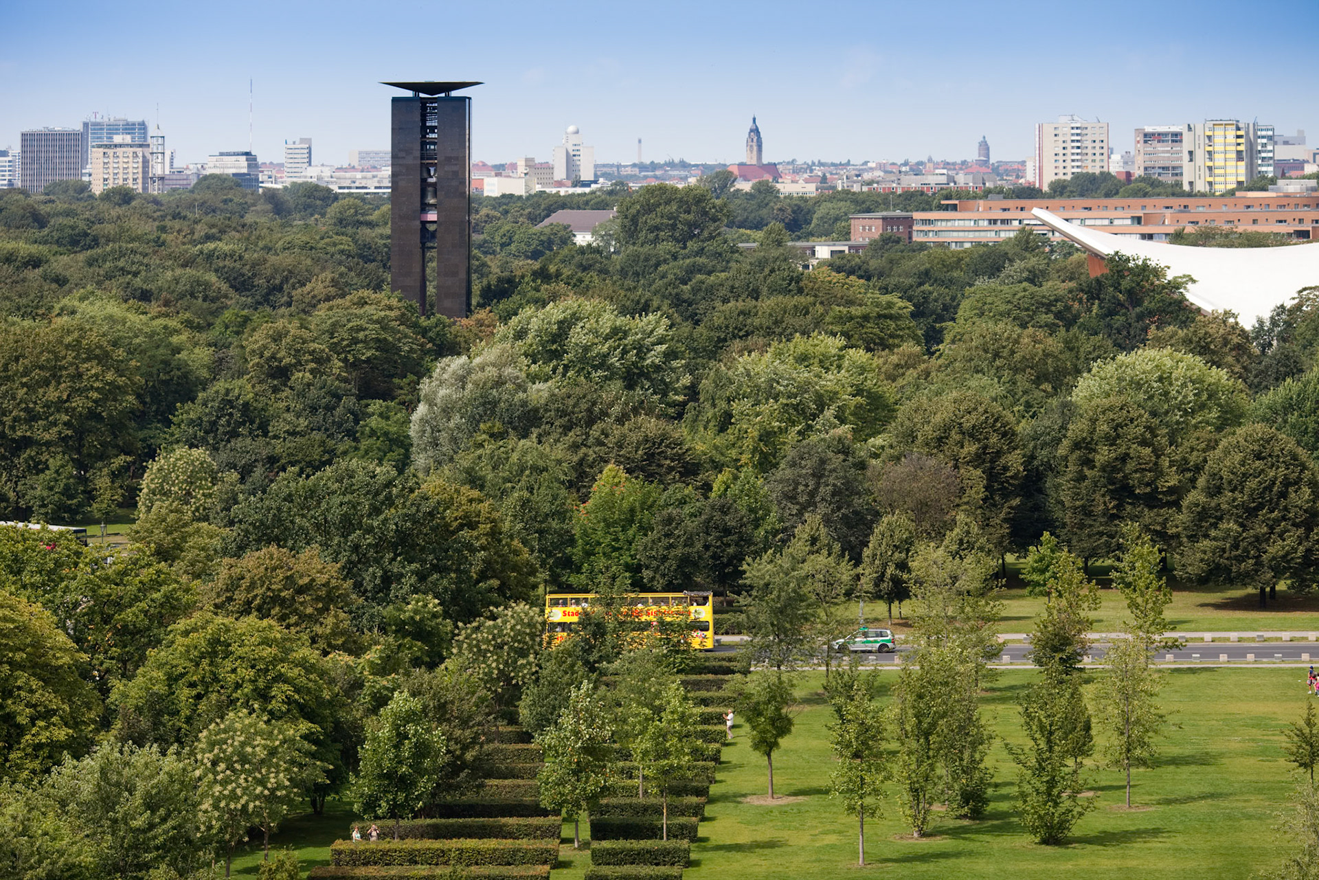 Elevated perspective of Tiergarten park with the Carillon tower visible amidst the greenery in Berlin, showcasing the cityscape.