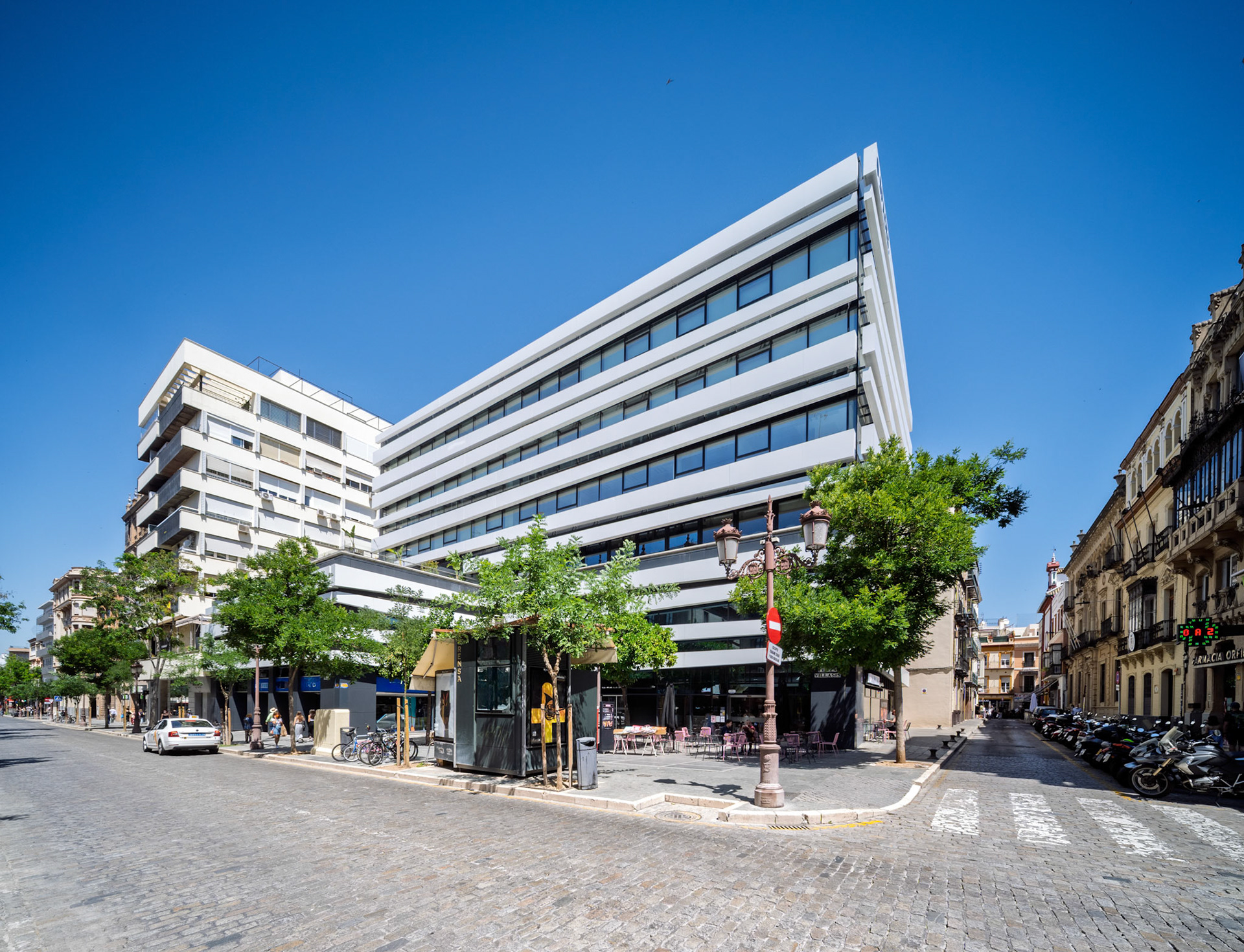 In central Seville, Edificio Villasís features modern design with white lines and balconies, home to creative professionals and vibrant coworking spaces.