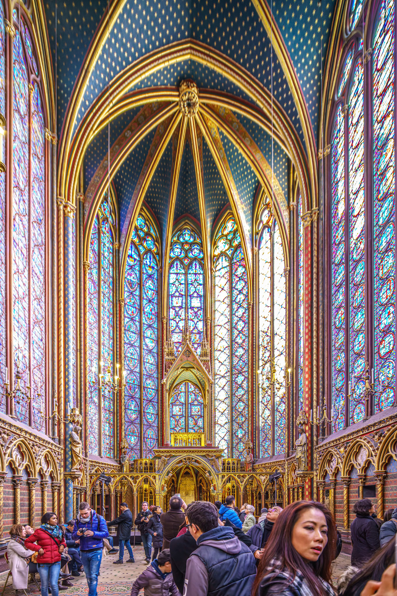 Tourists admire the stunning stained glass windows at the Sainte Chapelle.