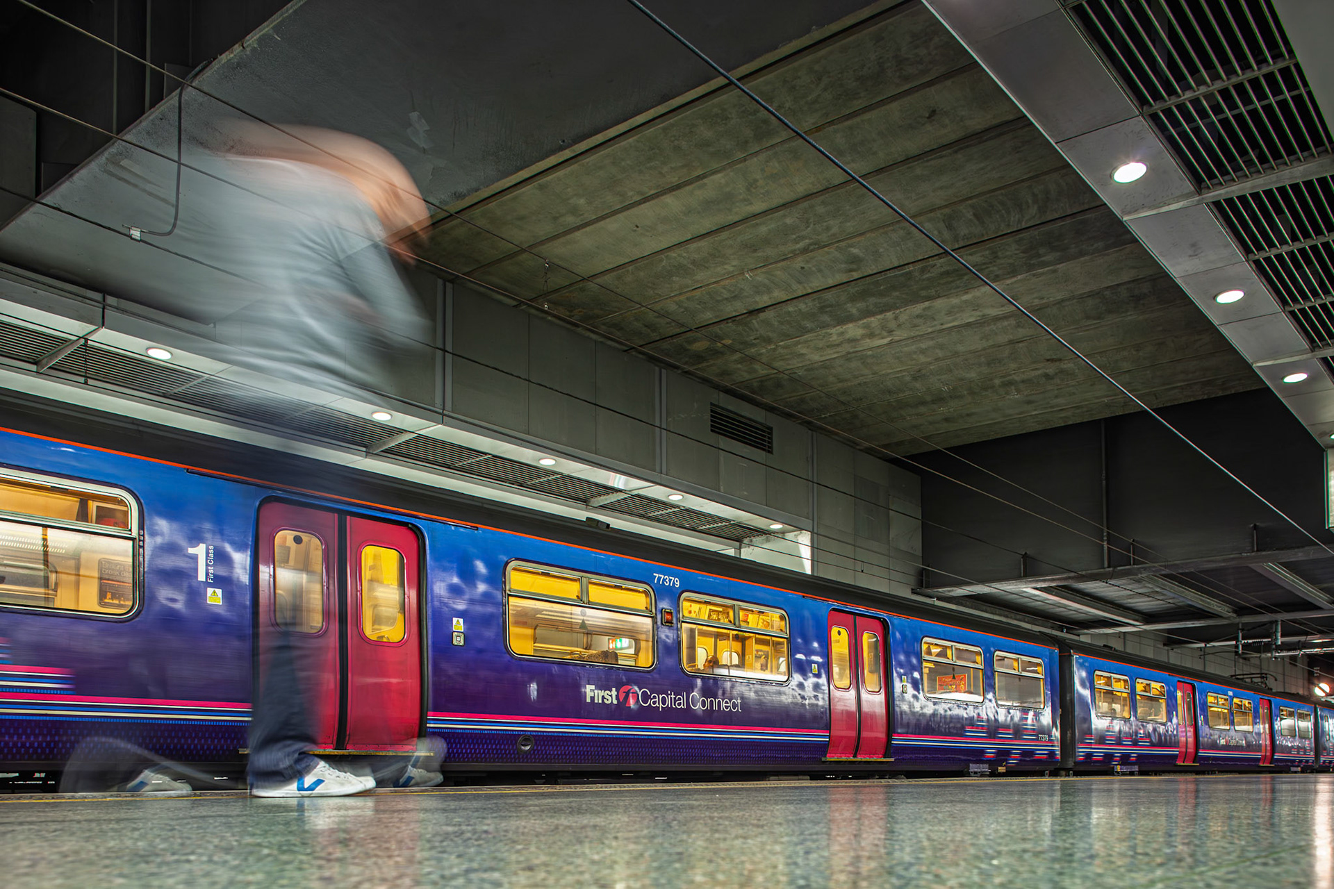 Train arrives at Saint Pancras International Station, bringing travelers in and out of London. People move around the platform as the journey begins.