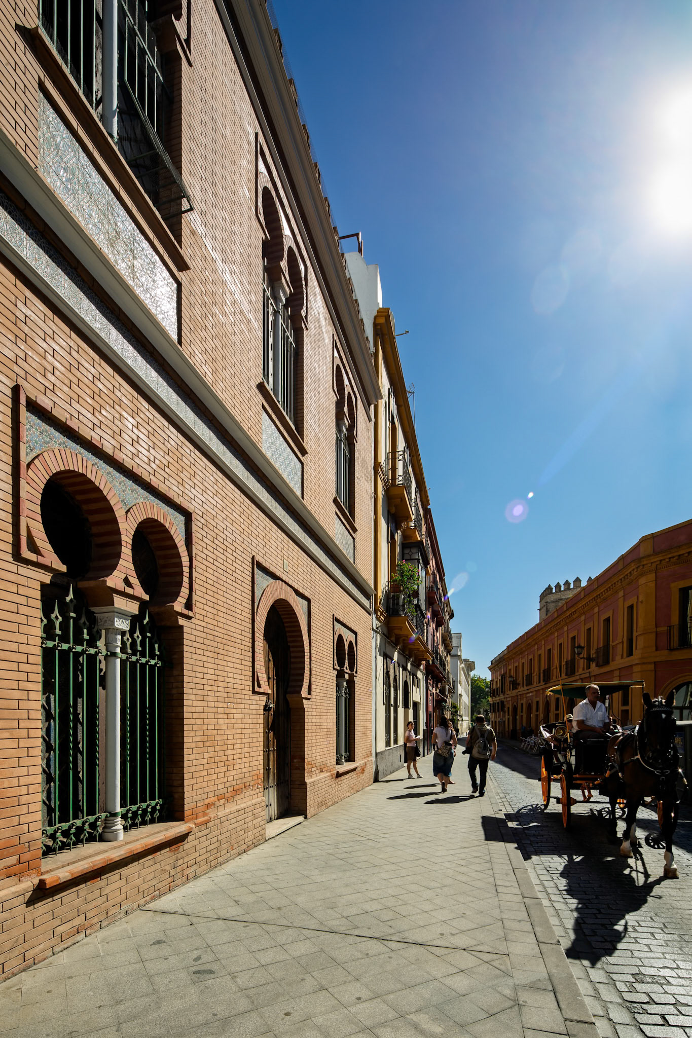 Seville, Spain, Aug 3 2012, Historic Seville building showcases neomudéjar architecture by Antonio Arevalo, reflecting Andalusia's cultural heritage in sunlight.