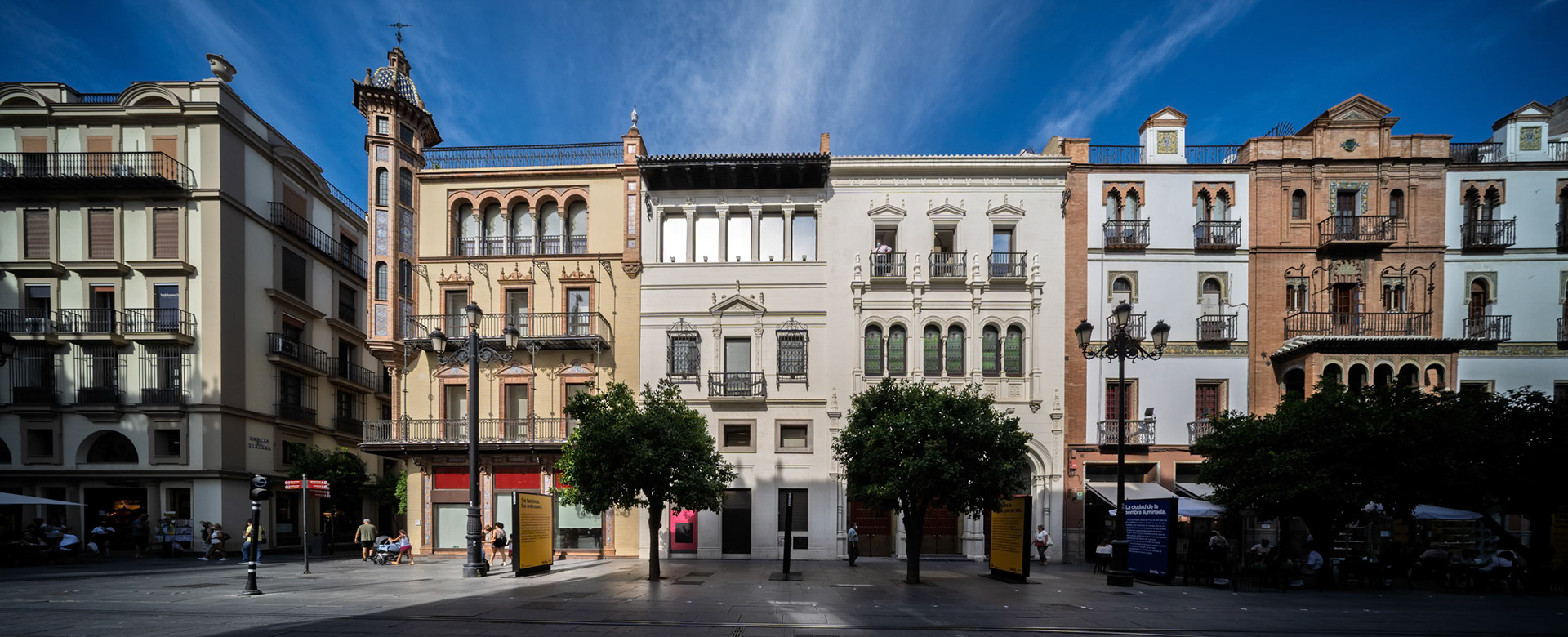 Seville—on Avenida de la Constitución, Aníbal González’s Casas Dávila (with tower), Hermanos González, and Scholtz showcase early 20th-century regionalist elegance.