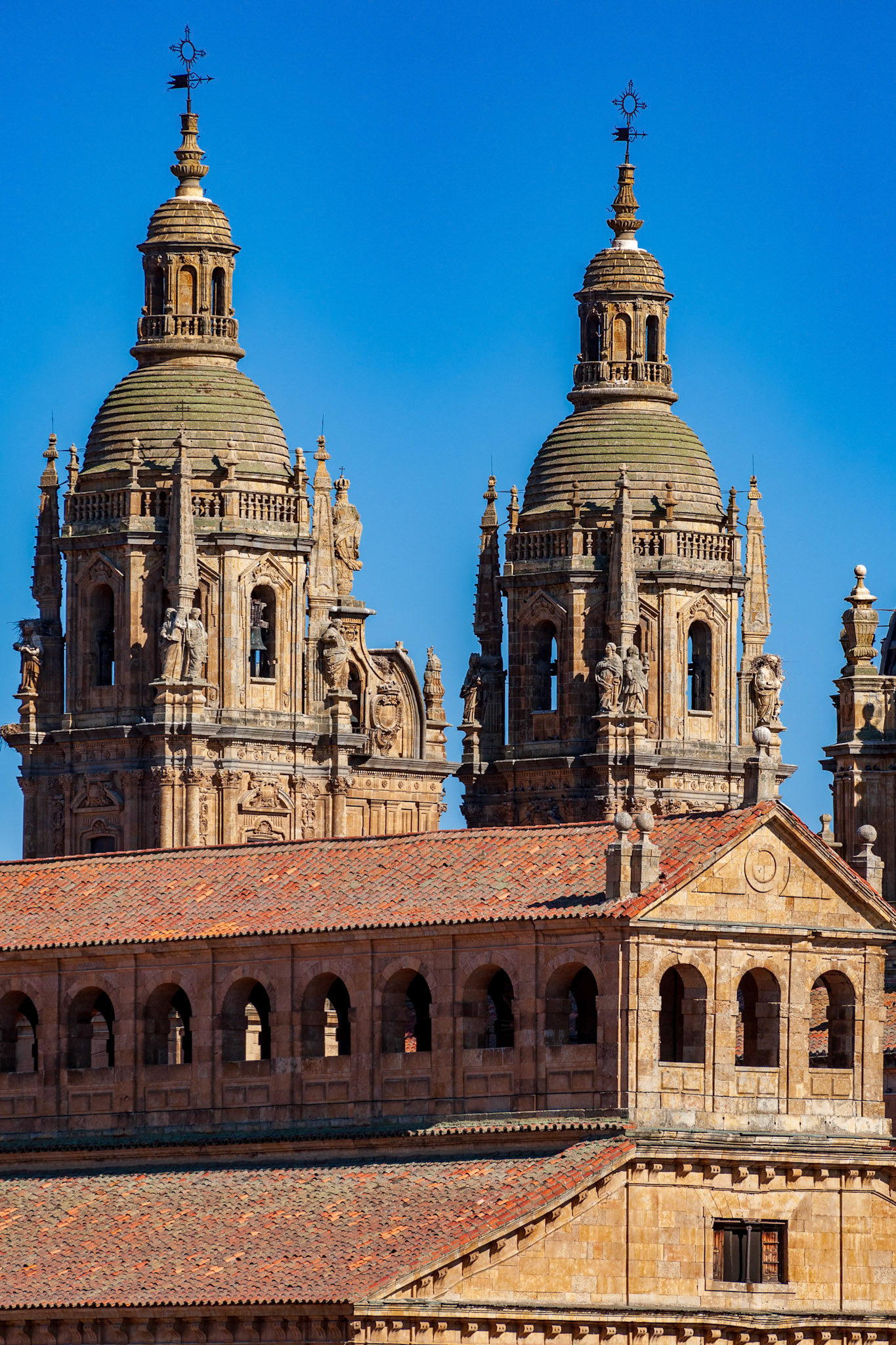 Clerecia church twin towers and university rooftops in Salamanca, Castilla y Leon, Spain.