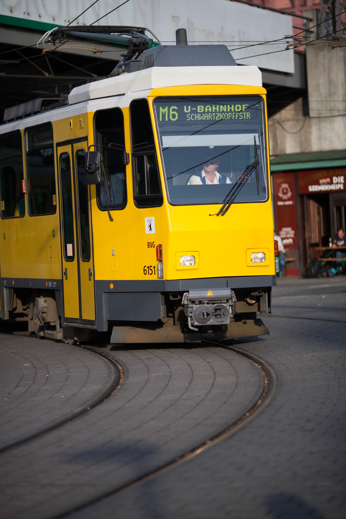 Berlin, Germany, July 27 2009, A vibrant yellow tram navigates the tracks at Alexanderplatz in Berlin, highlighting the city\'s efficient public transportation system.