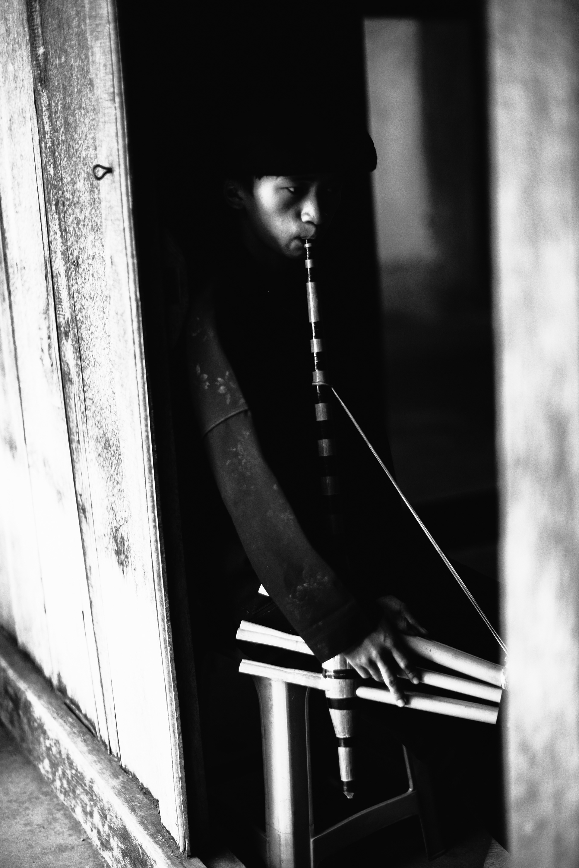 Boy playing the Qeej, a Hmong instrument. Ha Giang, Vietnam
