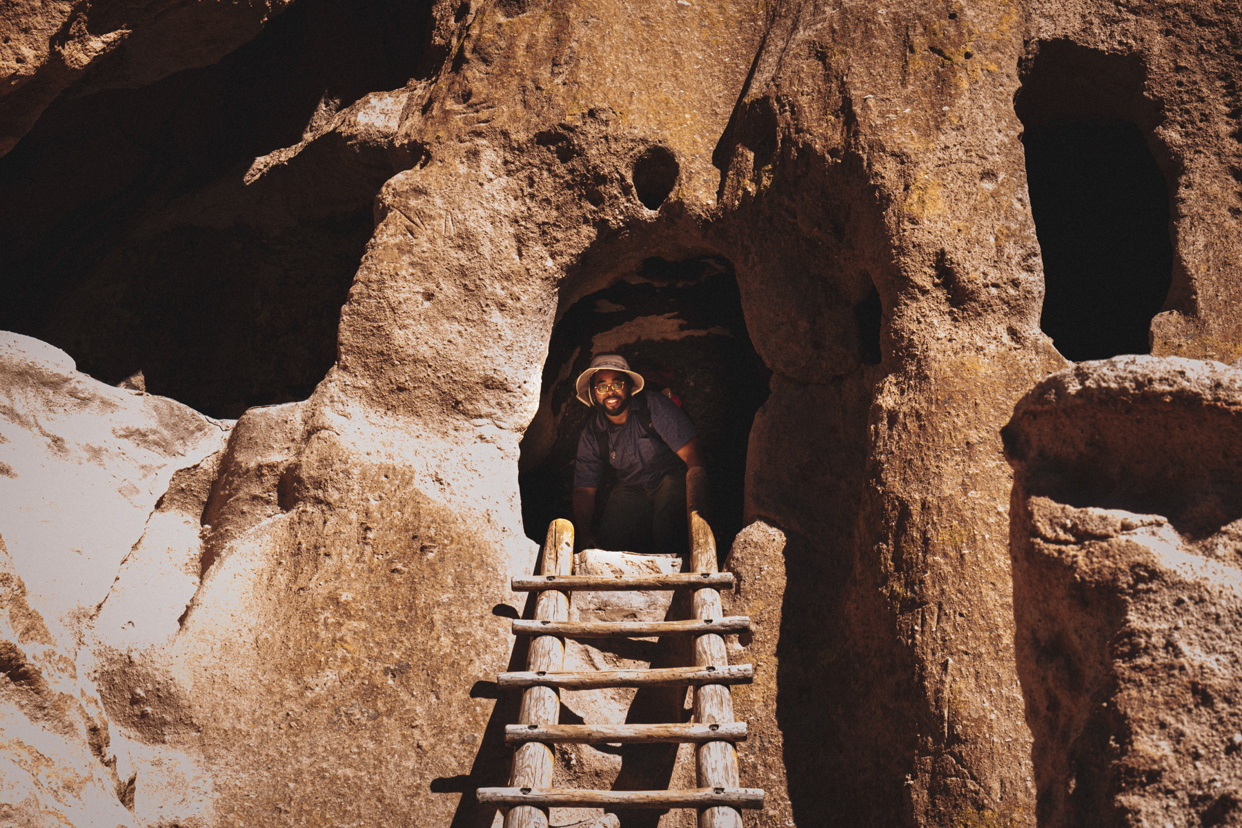 Brandon inside a cave with photography equipment.