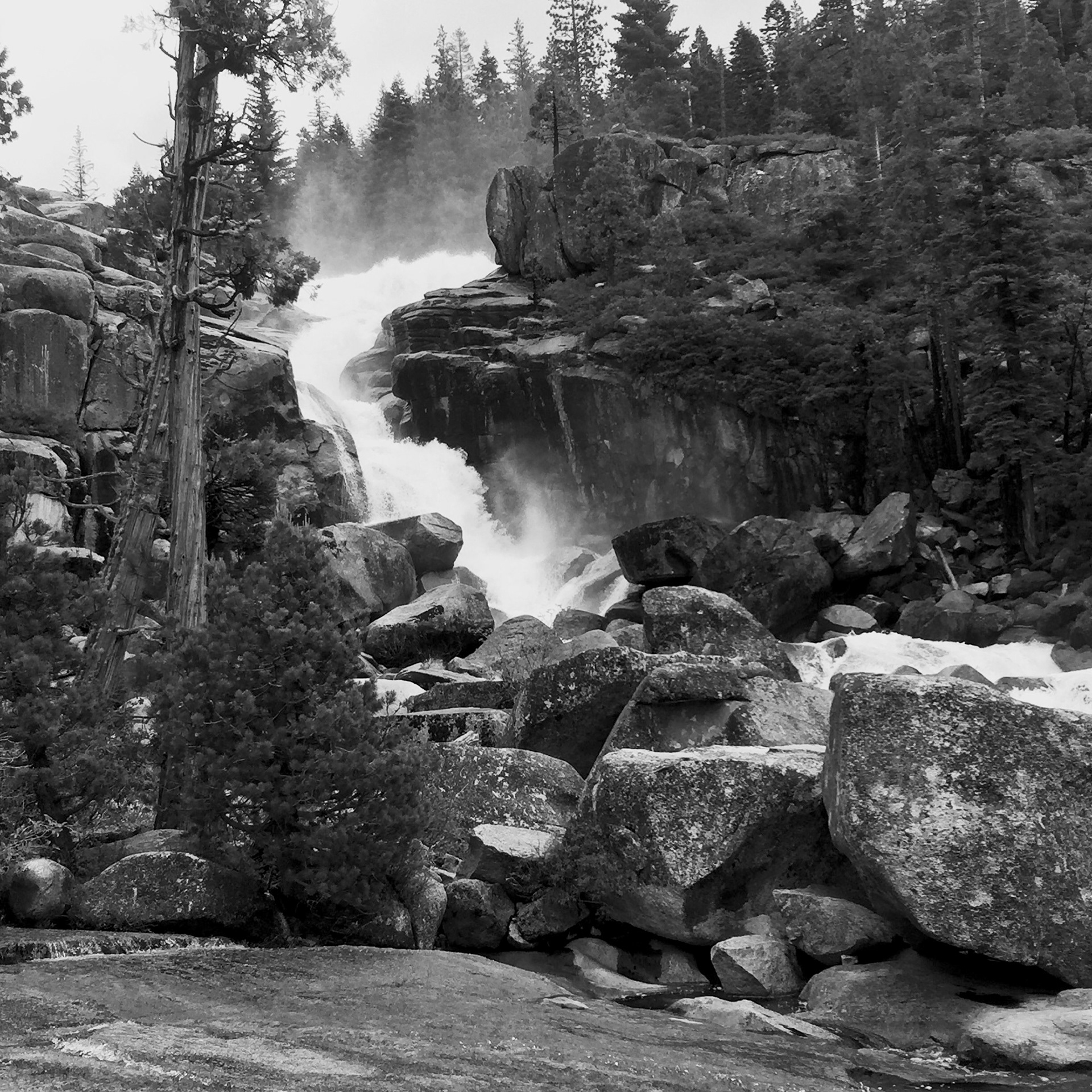 An outdoor scene with waterfall and rocks