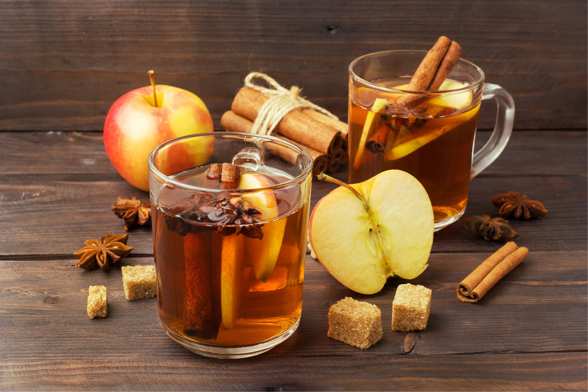 Glasses of orange mulled wine and apples