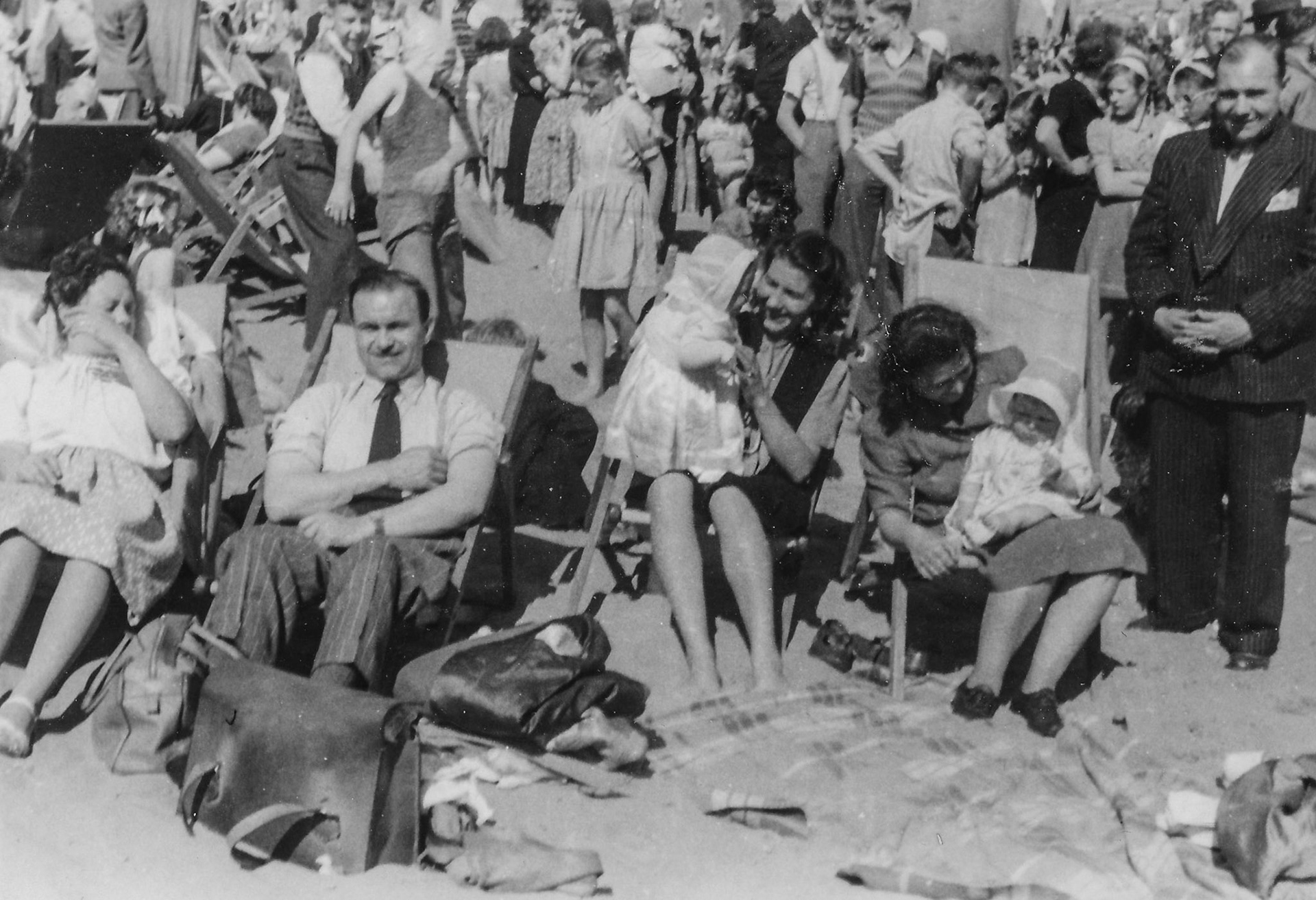 Ena, MaureenEdie, and Valerie. Crowds at Whitley Bay. Also Gladys and Jimmy Chambers on front deck chairs.