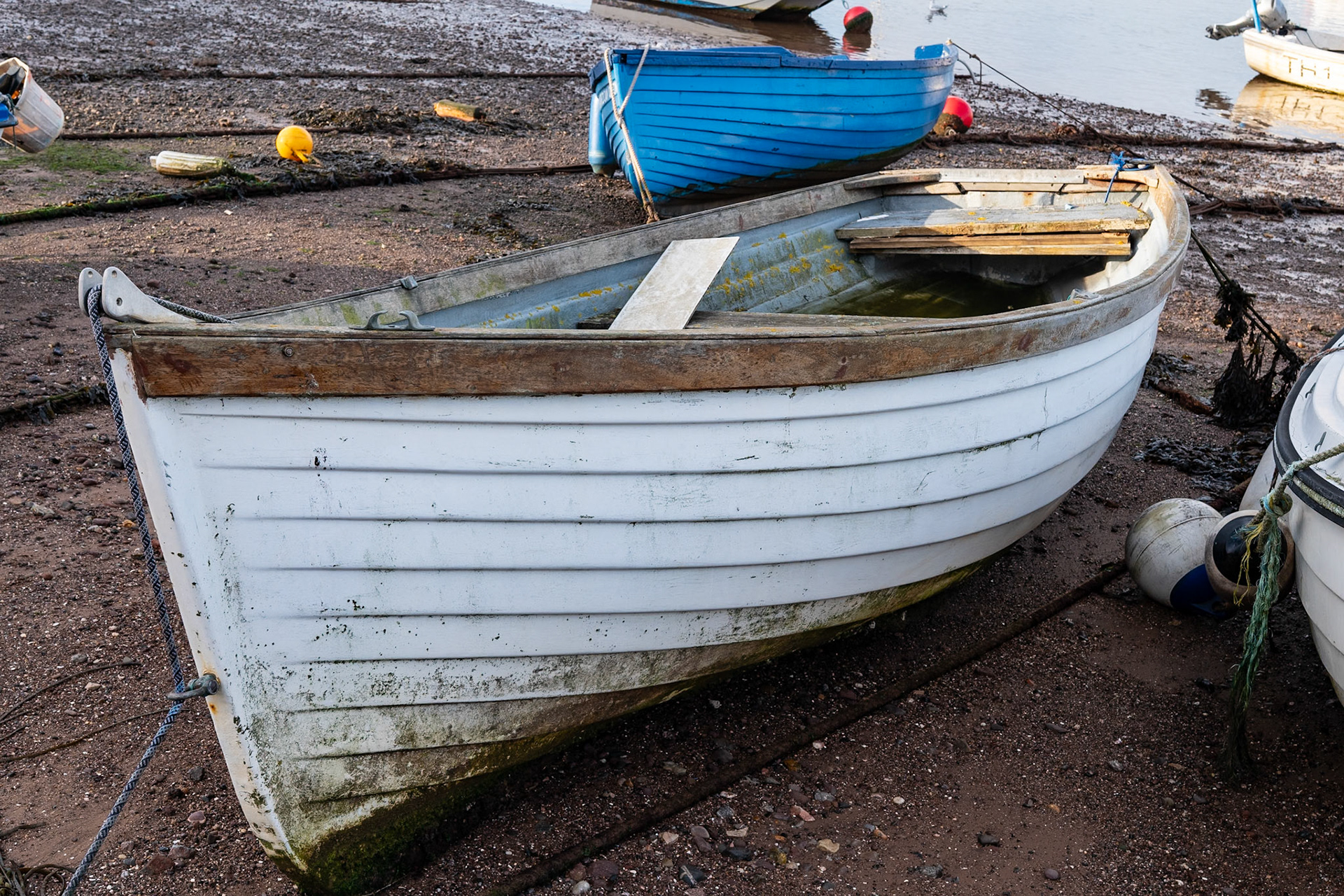 A boat on the beach at low tide