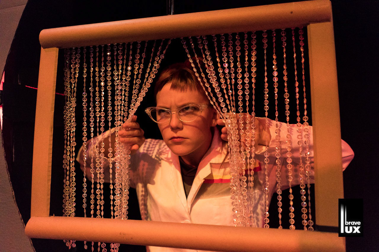 One of my favorite gags: beaded curtain to show 'static' in the viewfinder. BODY: Season Pass: Deux Over 2019 - Scenic, Puppets, Properties Design (Photo by Joe Mazza - BraveLux.com)