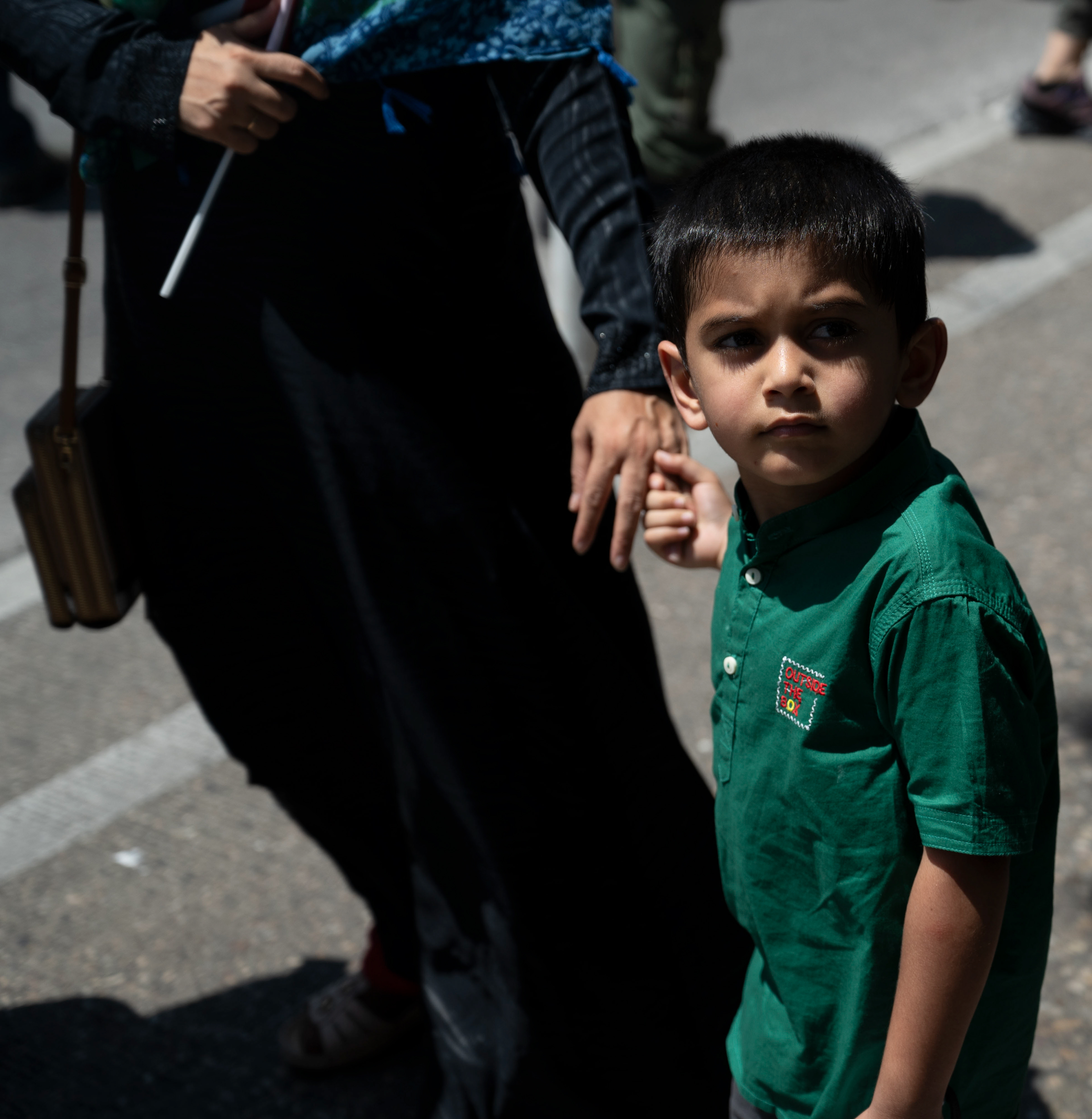 A child holds their mother's hand as the two march with the crowd during a pro-Palestinian demonstration near the Captiol in Austin, Texas on May 19, 2024.