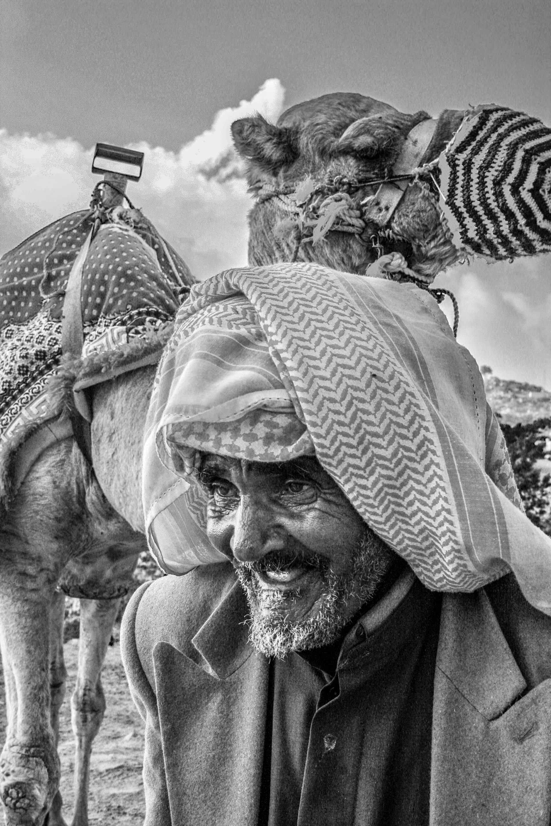 A camel wrangler and his camel.