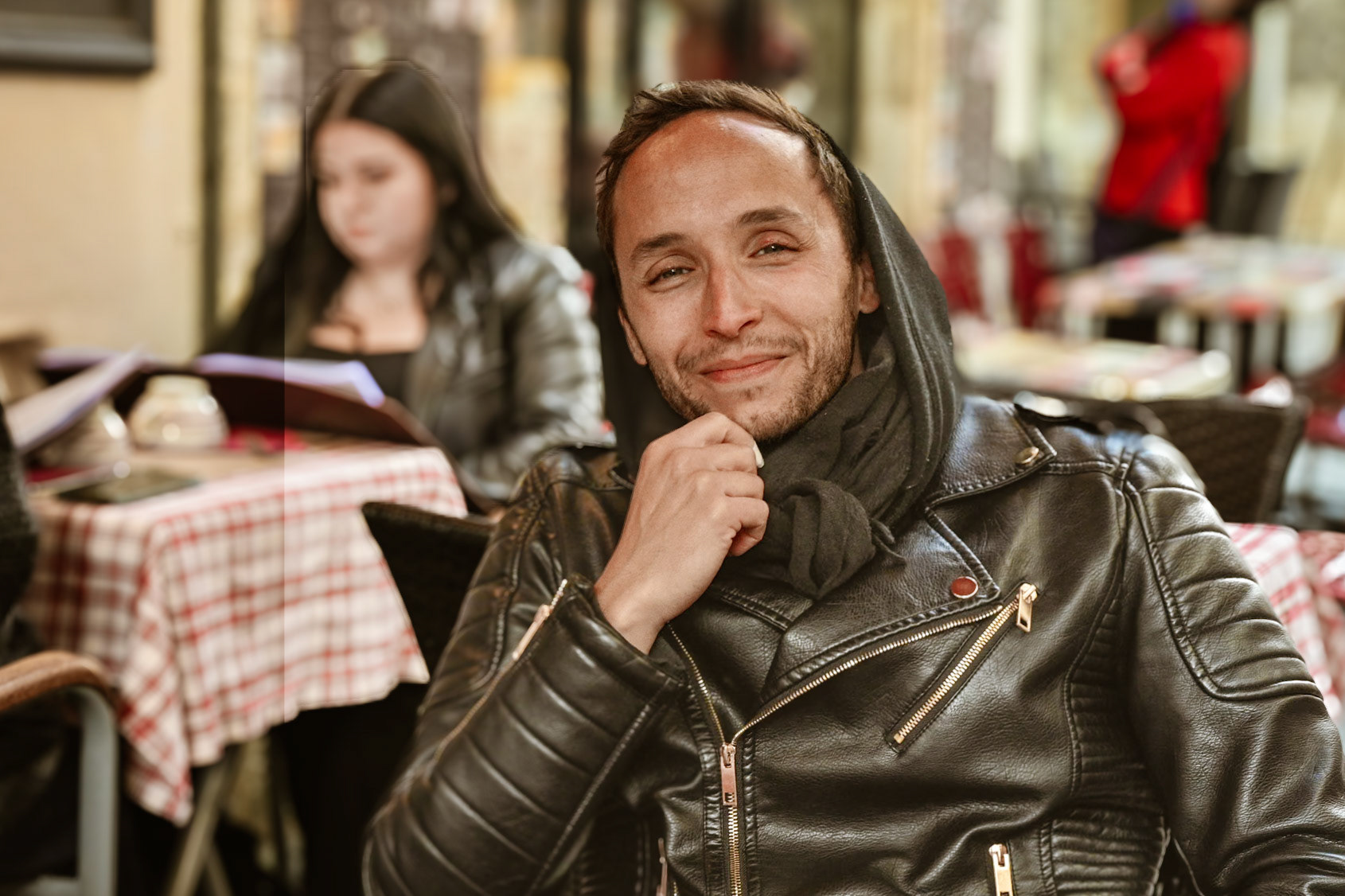 A young man looking cool in a sidewalk cafe in La Rochelle, France.