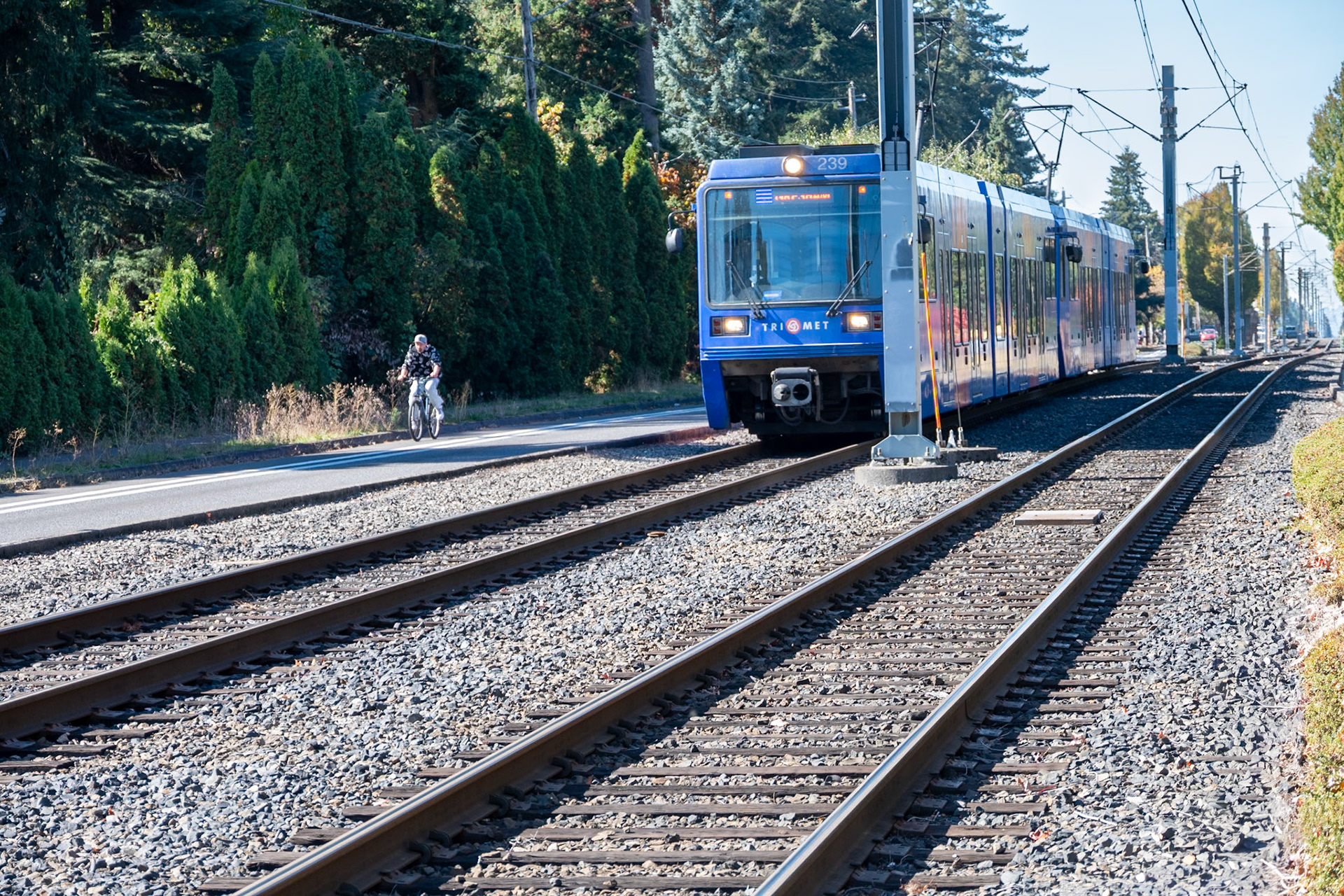 Bicyclist and MAX train heading east