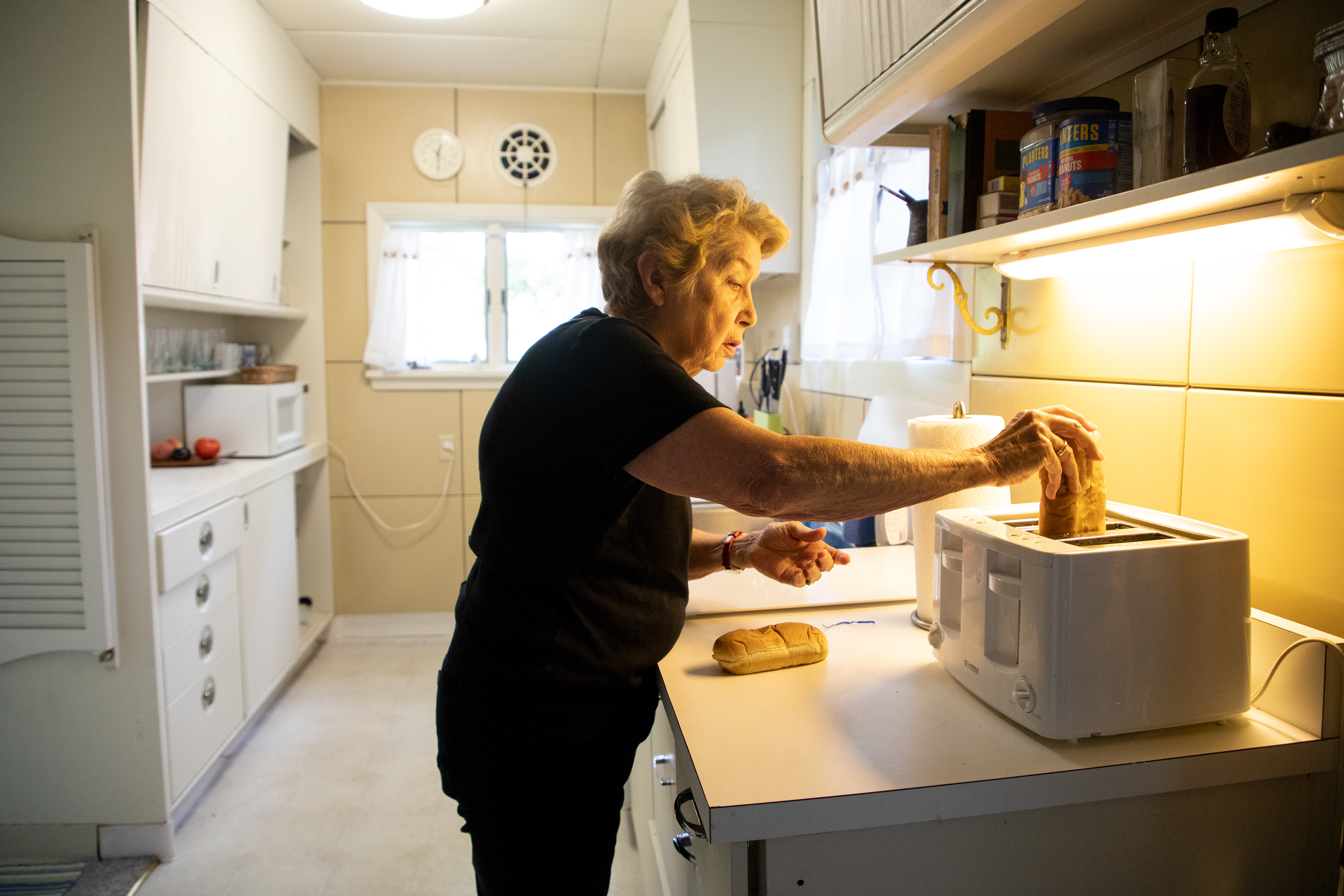 Zoe Barley makes lunch in her home, affectionately named "Steel Away," August 20, 2018 in Chautauqua, New York. Steel Away is an all-steel Lustron house built after World War II. While these magnetic homes were once popular, now fewer than 2,500 remain across the United States. Owners find community in an online forum where they swap tips on where to track down rare replacement parts.