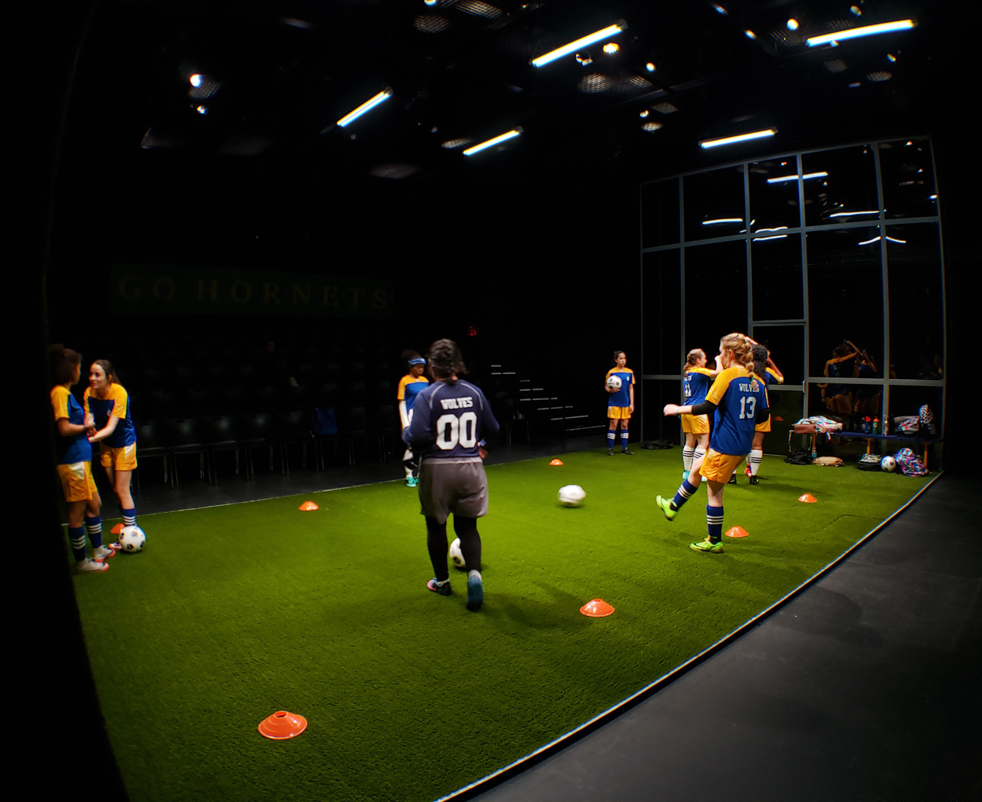 THE WOLVES TEAM PASSING SOCCER BALLS TO EACH OTHER WITH CONE DIVIDERS