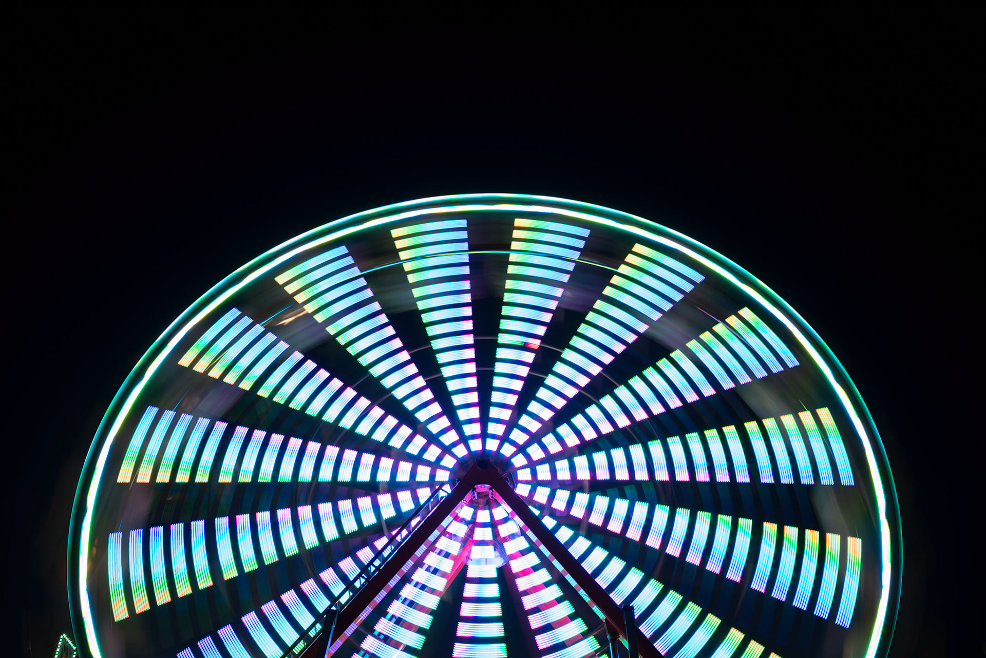Spinning ferris wheel at night, abstract
