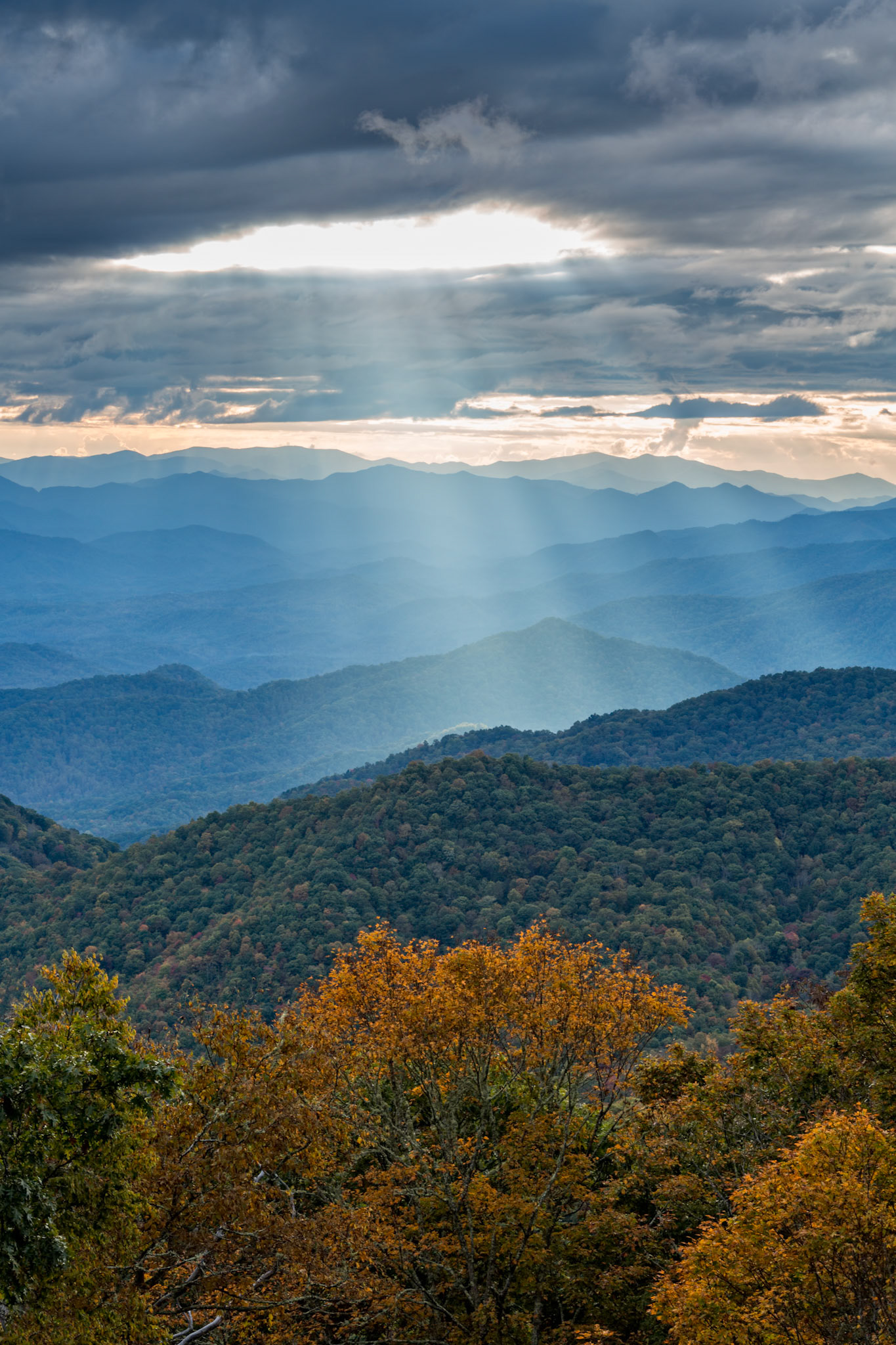 Sunbeams shine through a hole in the clouds