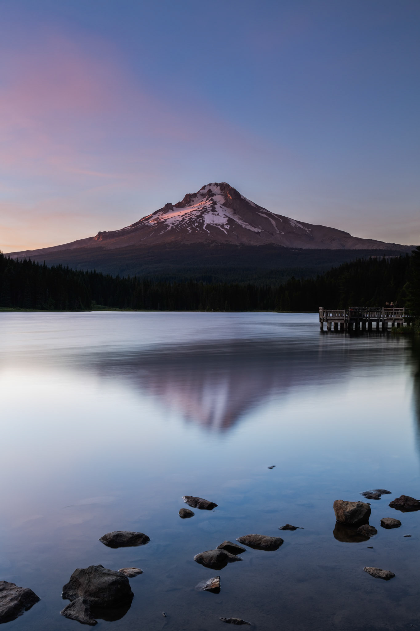 People standing on a dock watching the sunset on Mount Hood and Trillium Lake