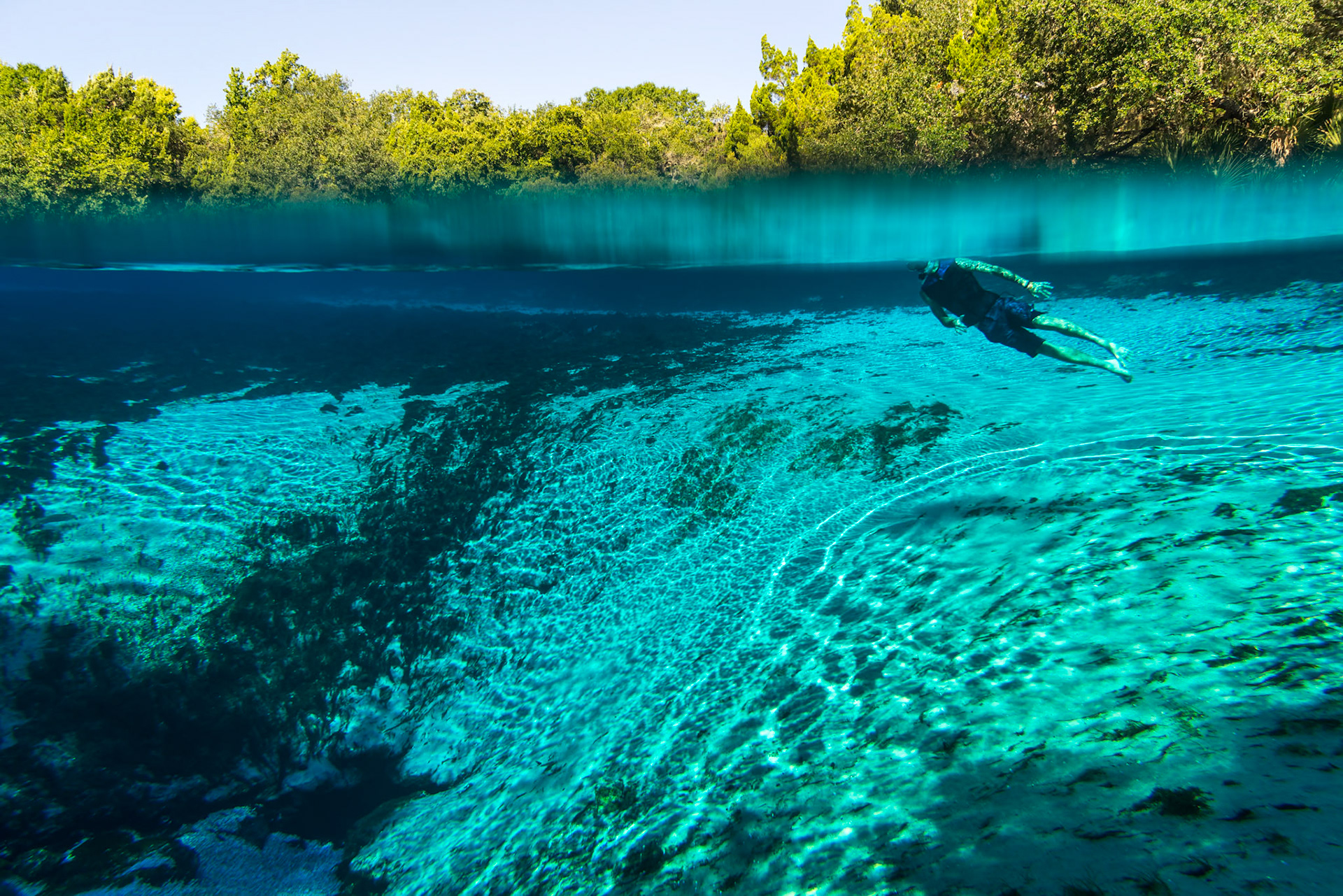 A teenager snorkeling in a fresh water spring in Florida