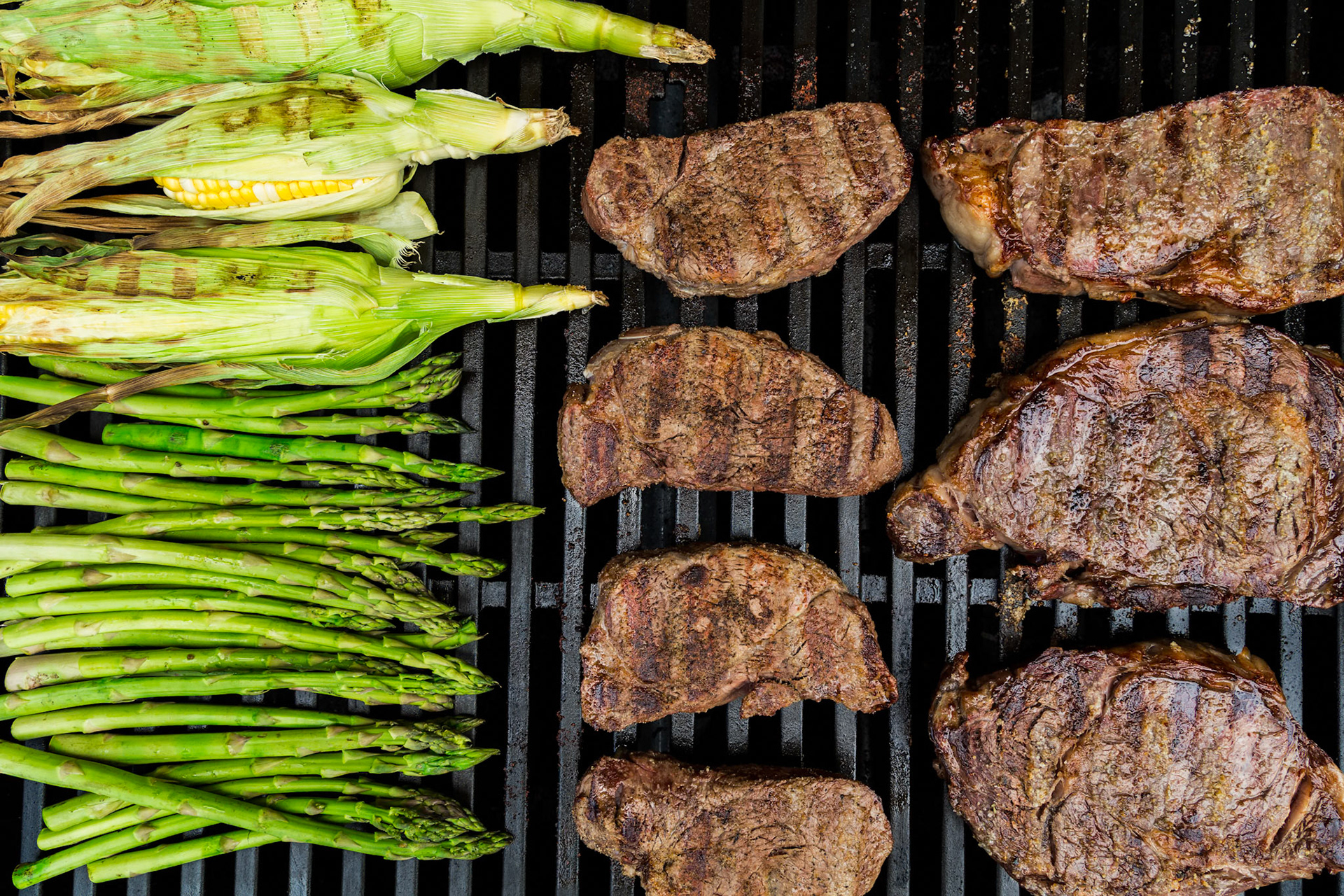 Grilling steaks, asparagus and corn on the cob
