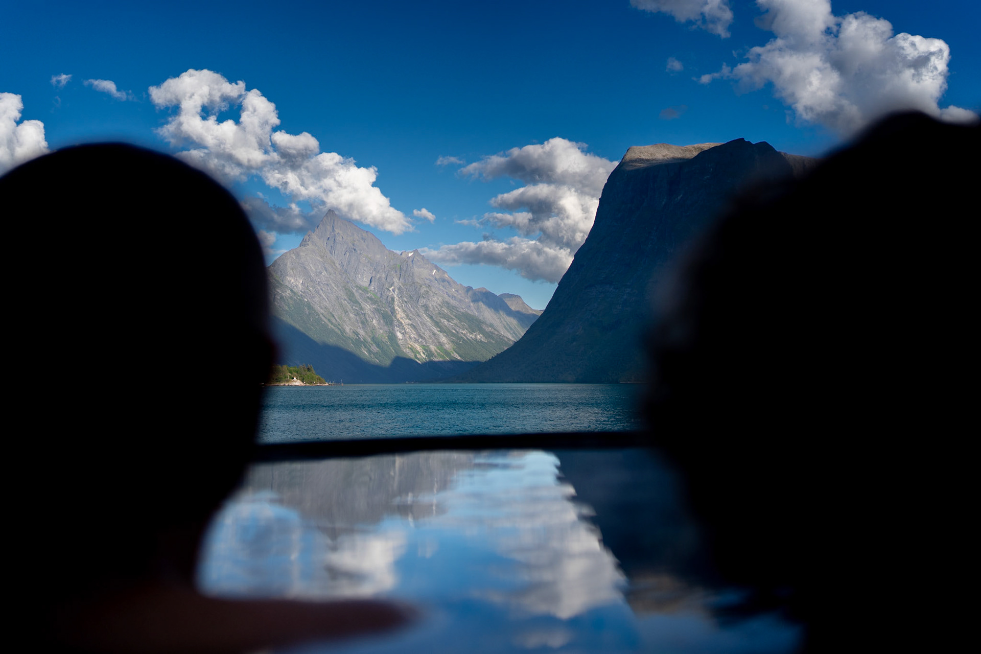 people in bathtub, in the background are beautiful mountains