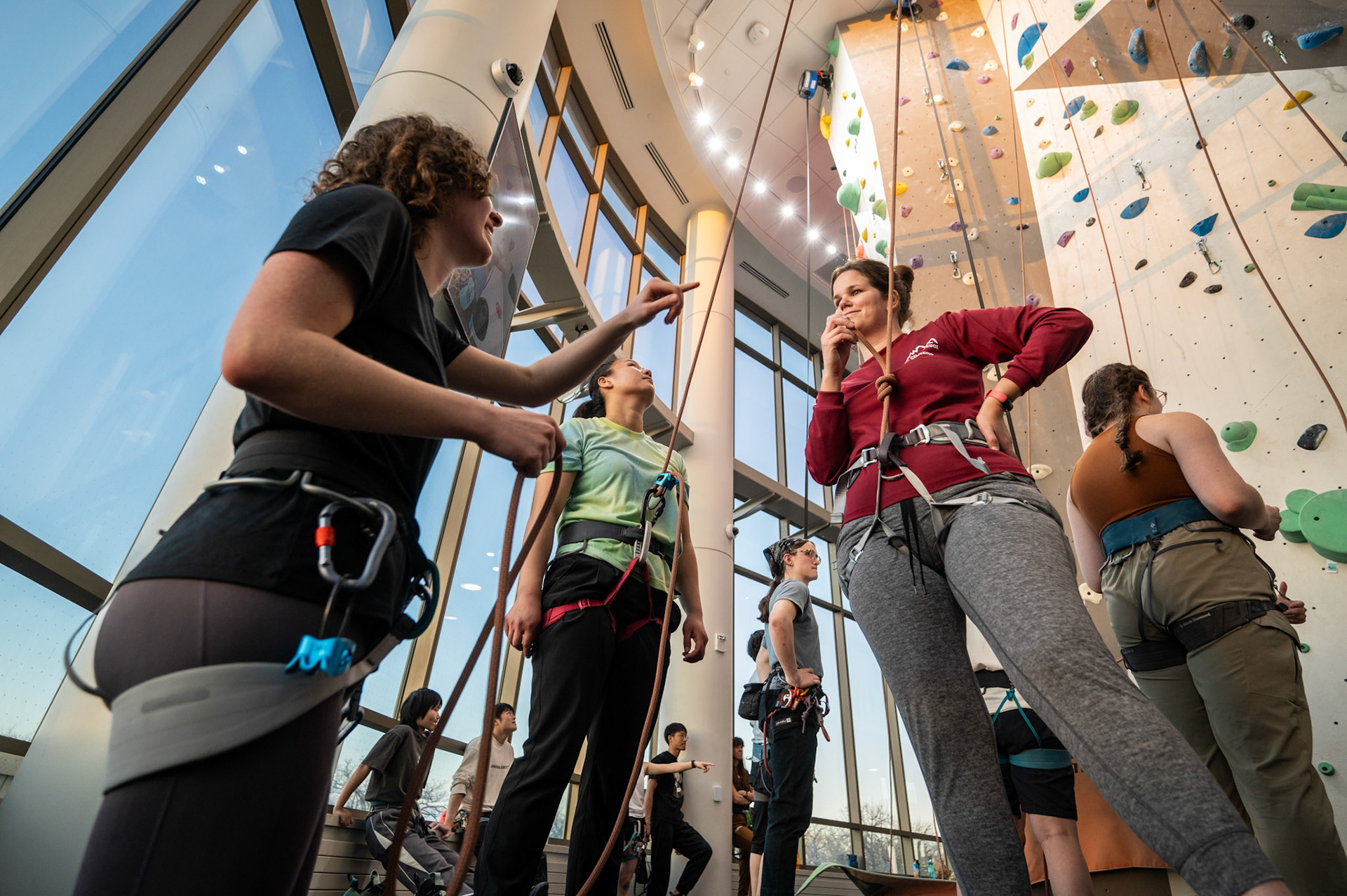 Ali Mueller (left) teaches Mikayla Siegel (center) and Charlotte VanHecke (right) how to belay during a Top Rope Belay Lesson at the Bakke Recreation &amp; Wellbeing Center’s Mt. Mendota at the University of Wisconsin-Madison on March 15, 2024. (Photo by MK Denton / UW–Madison)