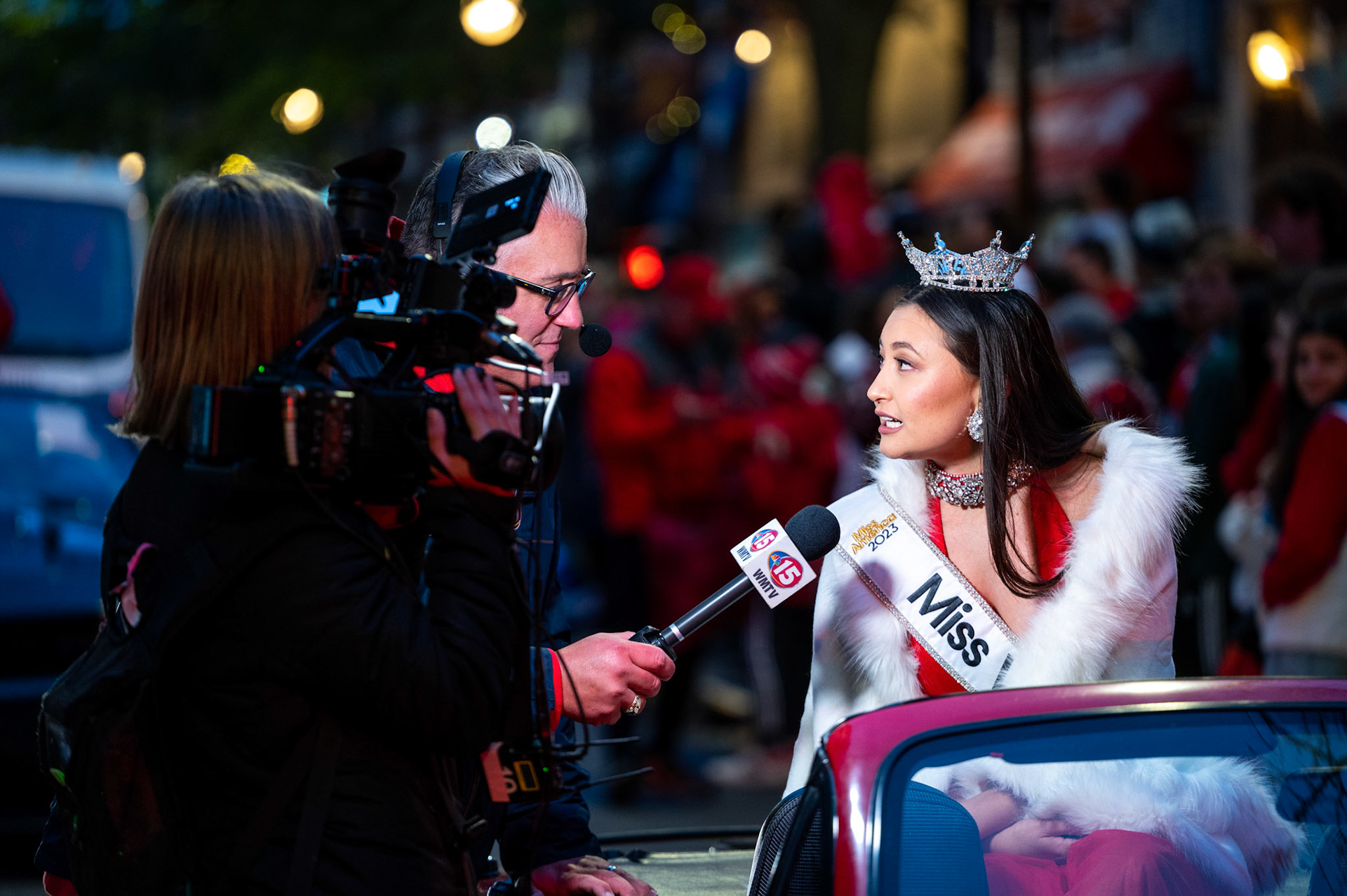 Miss Wisconsin Lila Szyryj conducts an on-camera interview with a local tv station during UW Homecoming Parade at the University of Wisconsin-Madison on Oct. 6, 2023. (Photo by MK Denton / UW–Madison)