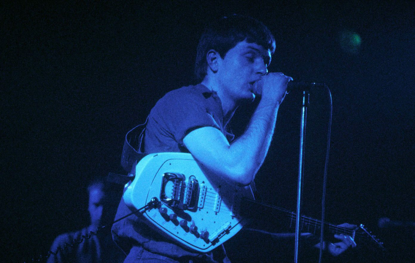 Photo of Ian Curtis Ian Curtis performing live onstage, playing Vox Phantom Special VI guitar CREDIT: Chris Mills/Redferns