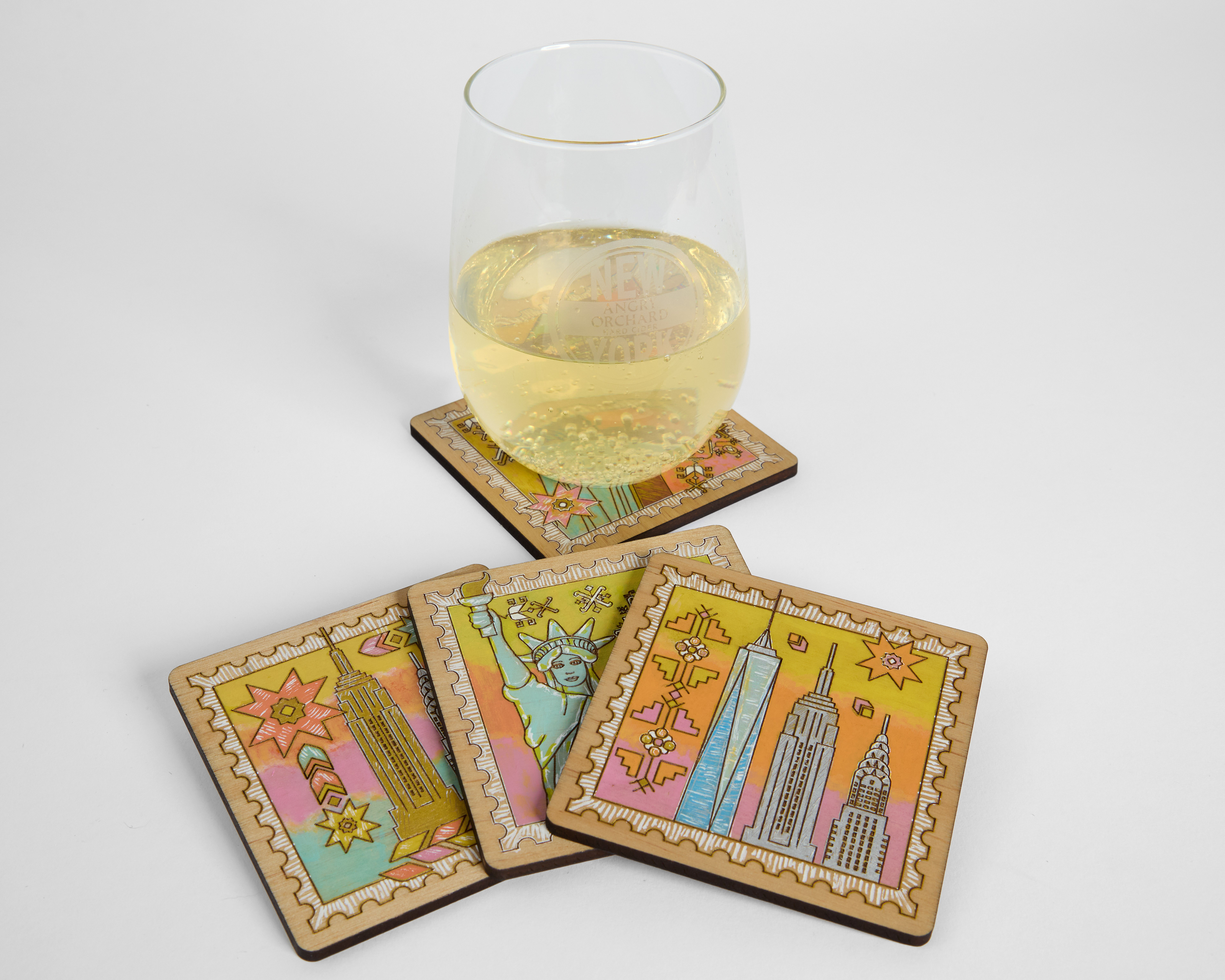 Hand-painted laser cut wood coasters with elements from Bulgarian embroidery and New York monuments