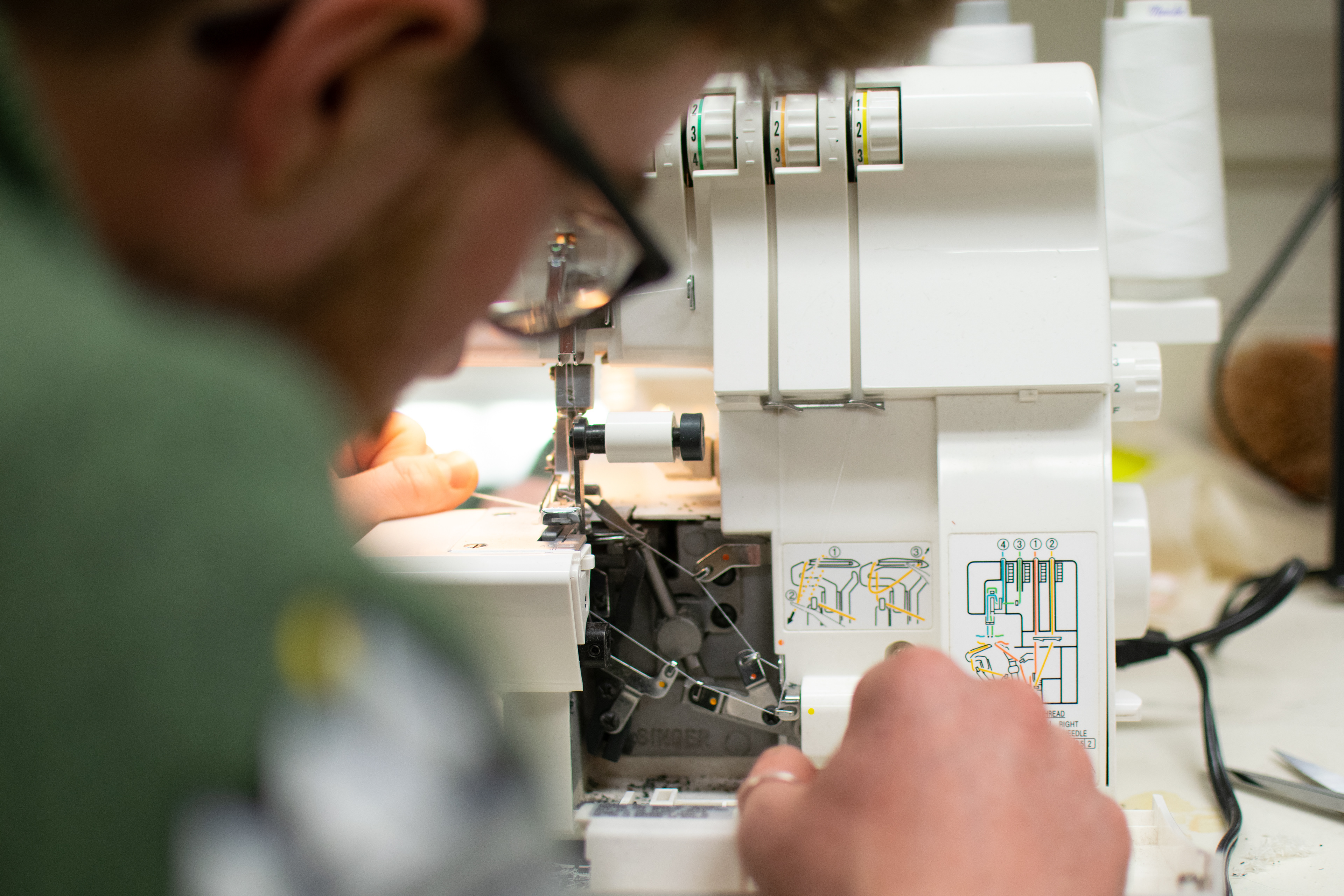 Sam L. fixes a machine in the Messiah University theater department, where he designed costumes after graduating. His love of handmade clothes began after taking a Wearable Art class.