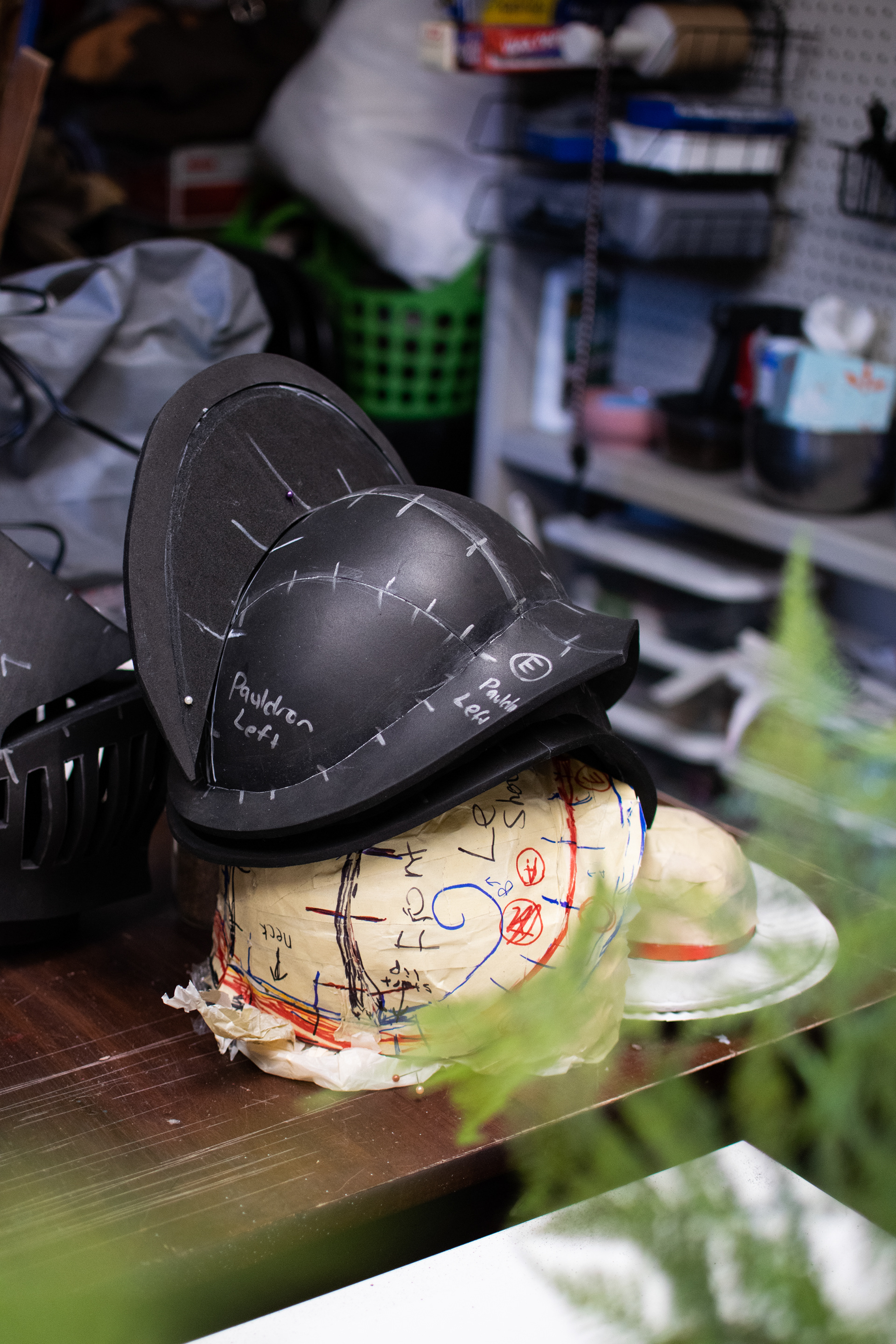 The original form for the shoulderpiece was modeled from trash bags and paper - Berger will use whatever is on hand. The dotted lines show where she will cut up the form, lay it flat, and create a set of 2D patterns to follow.